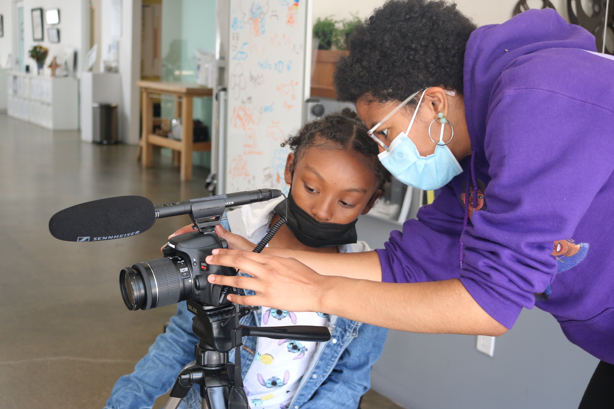  Teaching Assistant Isa helps a filmmaking student set up a shot. 