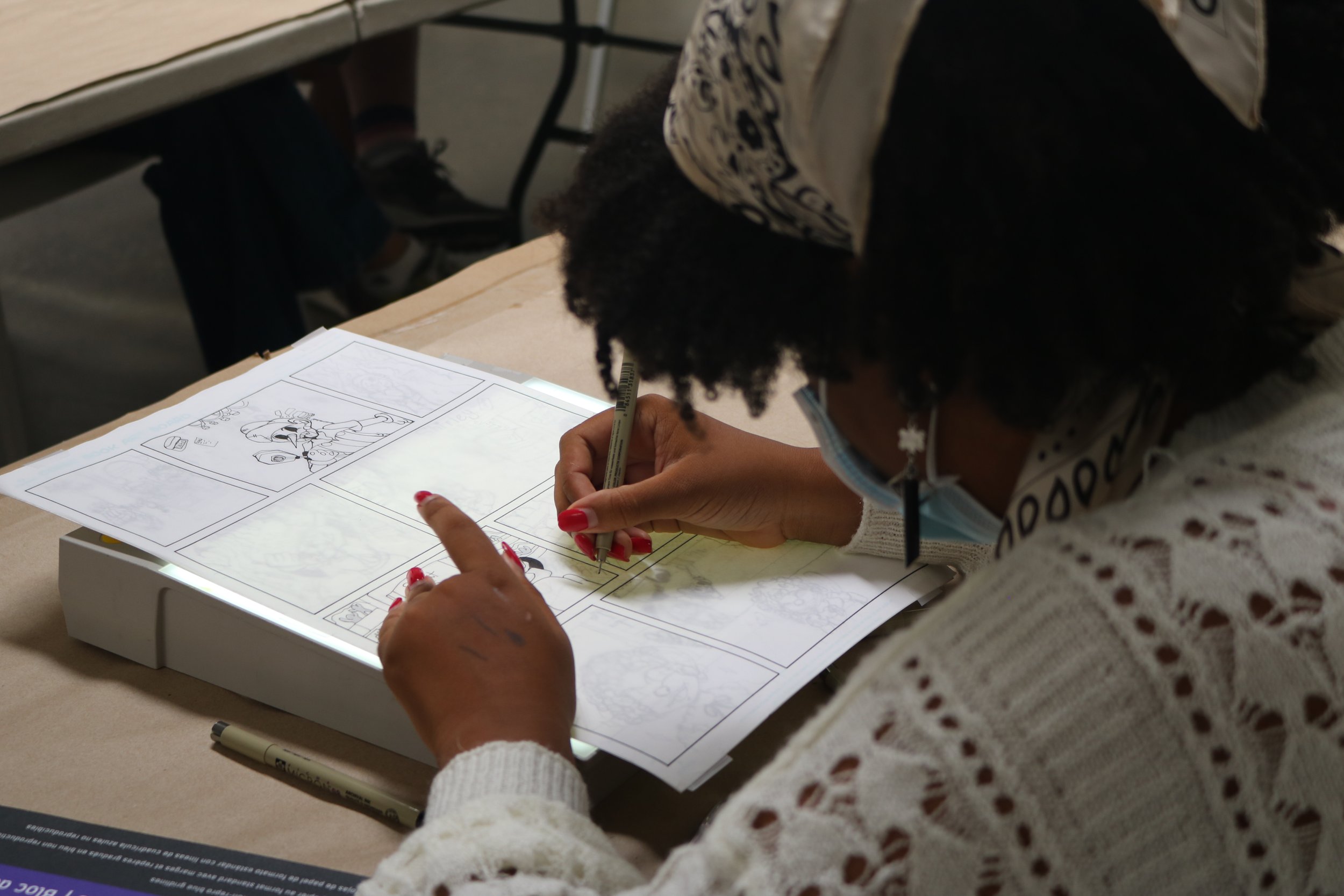  A comics students uses a light box to trace. 