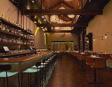 Custom "L" shaped 30' long bar top in a Chicago restaurant. EcoDomo manufactured & wrapped the bar top with the customer's own leather. 
