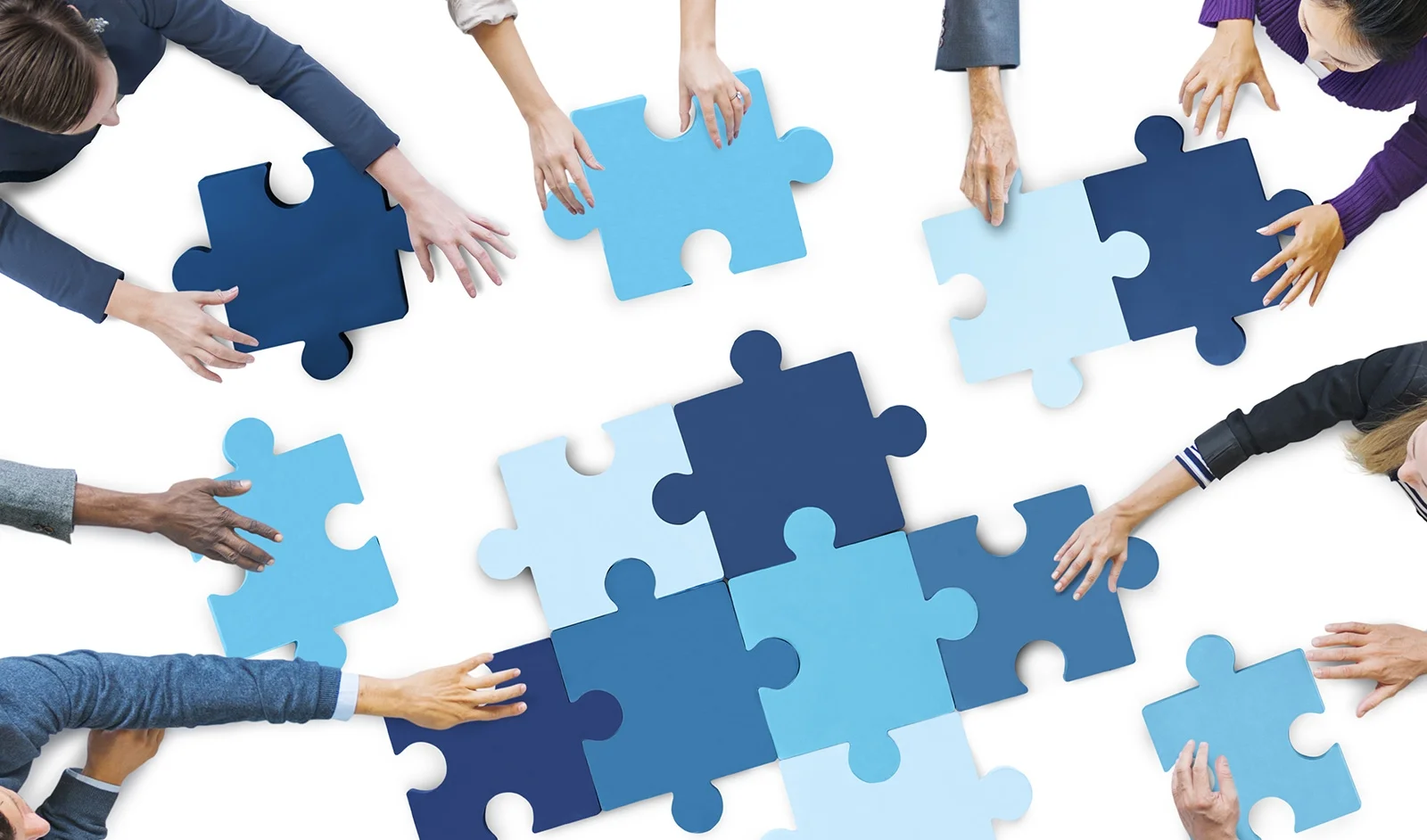 BusinessPeoplePiecingPuzzlePieces.jpg