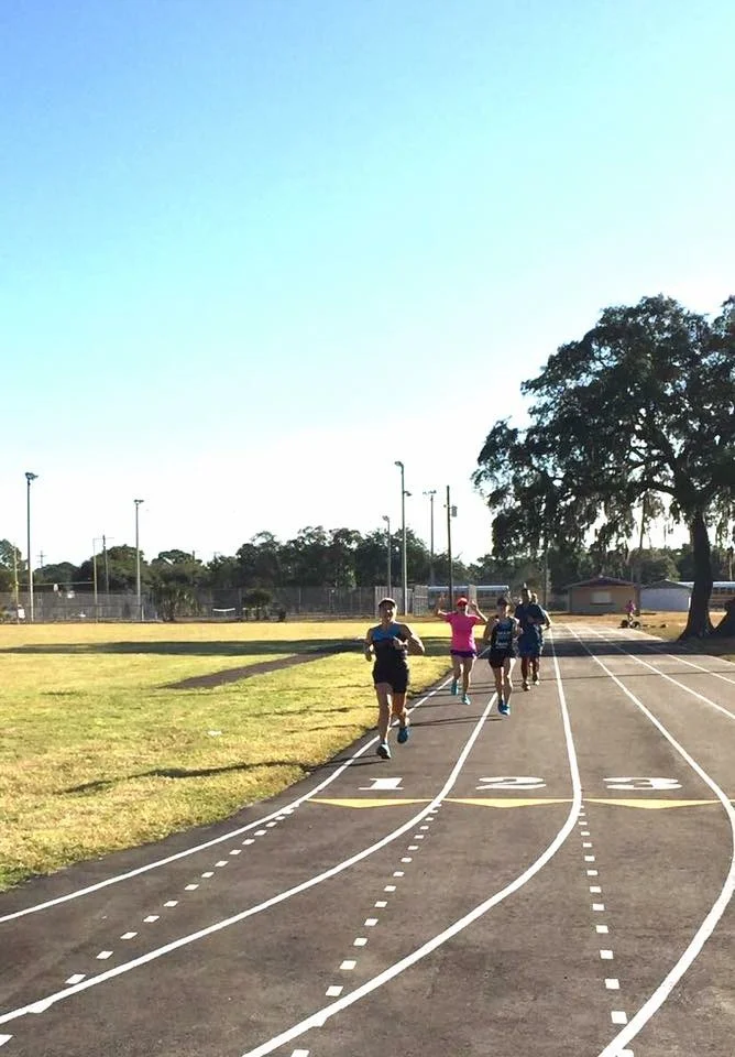 Forzafit athletes during a run coaching session on a track