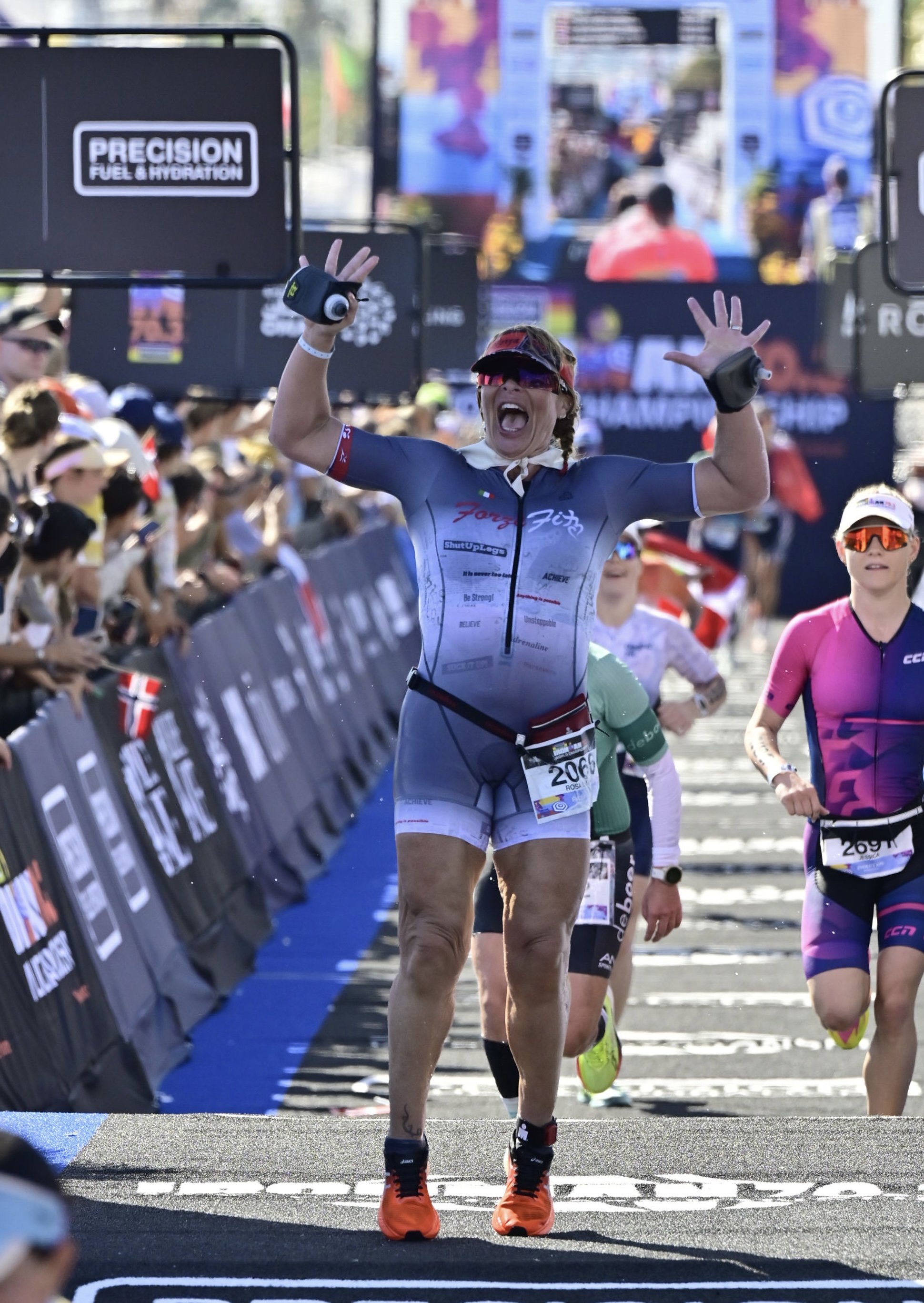 Rosa Laura celebrating as she approaches the finish line at the 2026 IRONMAN 70.3 World Championship in Nice, France.