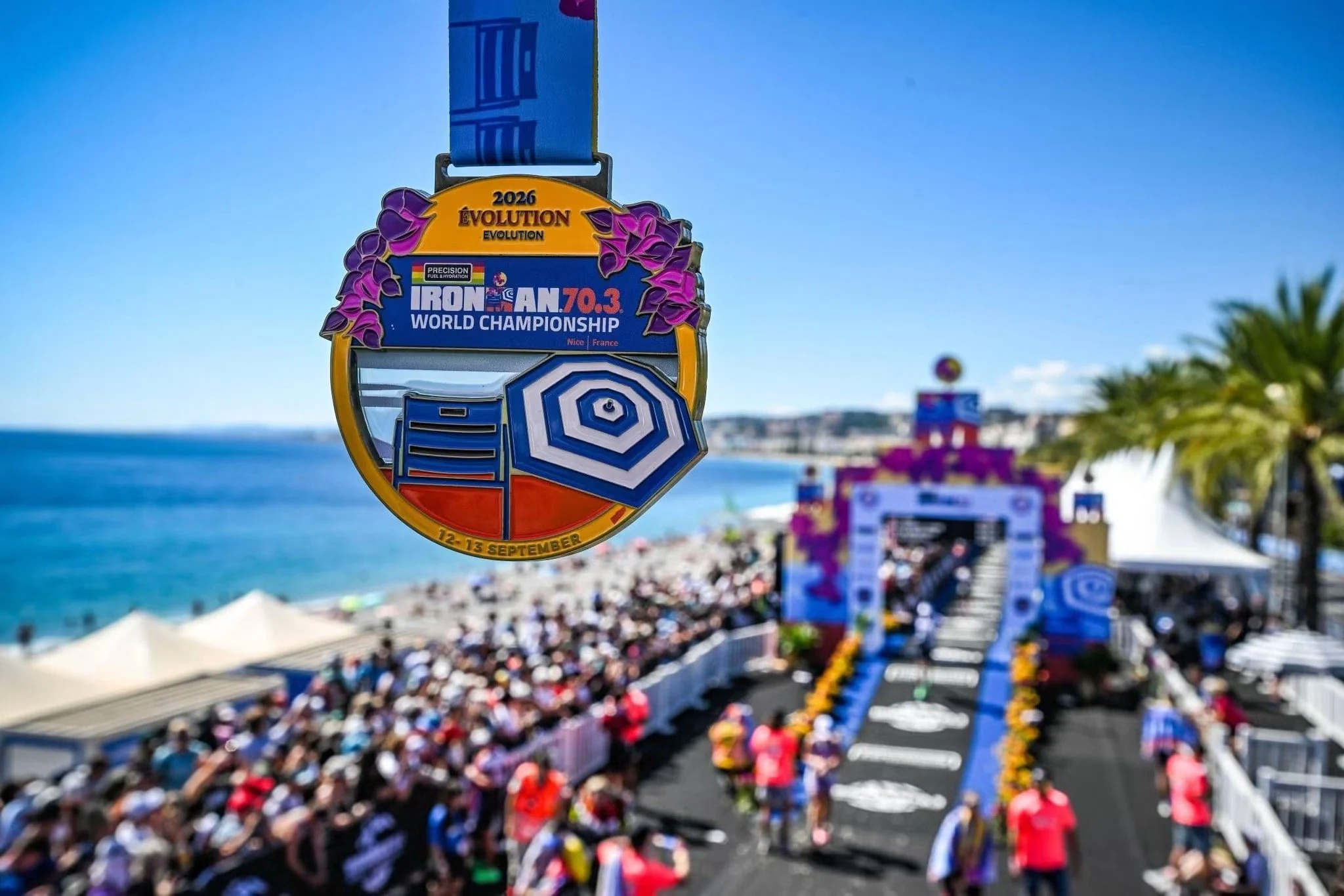2026 IRONMAN 70.3 World Championship finisher medal overlooking the Mediterranean Sea and finish line in Nice, France.