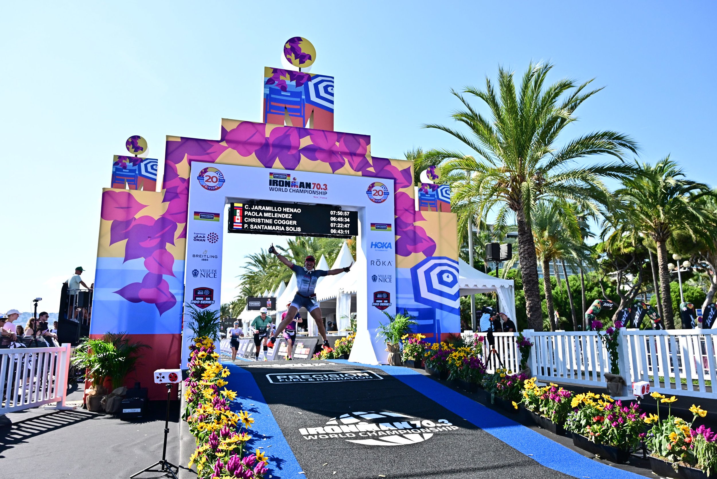 Rosa Laura Elbooz jumping in celebration at the finish line of the 2026 IRONMAN 70.3 World Championship in Nice, France.