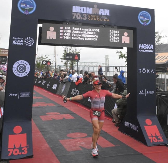 Rosa Laura crossing the IRONMAN 70.3 North Carolina 2026 finish, placing third in her age group.