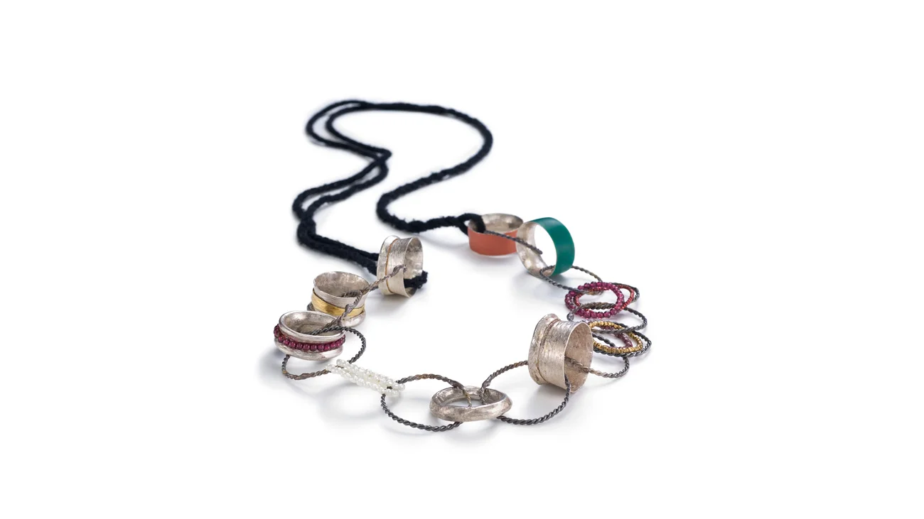 Materials: sterling silver, 18k gold, silk, garnet, resin Date: 2010