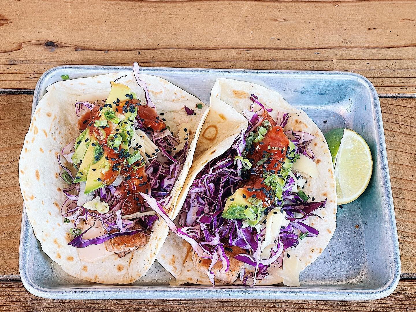 Ahi Tacos now in session 🐟 

&bull;seared ahi, cabbage, cucumber, pickled ginger, green onions, avocado, sesame seeds, soy ginger lime cream + asian red pepper sauce, all inside a fresh flour tortilla&bull;