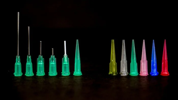  The printer has a variety of nozzles that the team and I tested in our application processes. On the left, nozzles with stainless nozzles. On the right, varying nozzle diameters from big (1 mm) to small (.025mm). 
