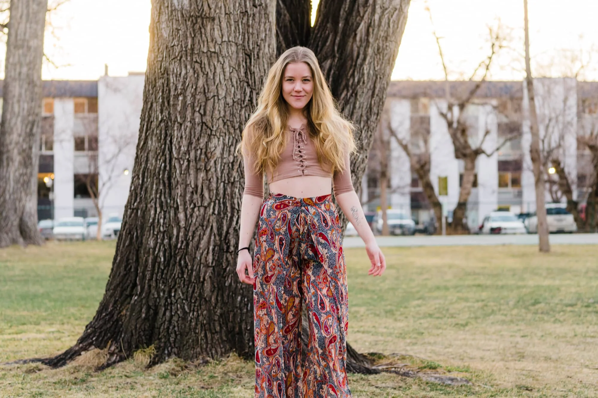 Portrait of bohemian girl in front of a tree.