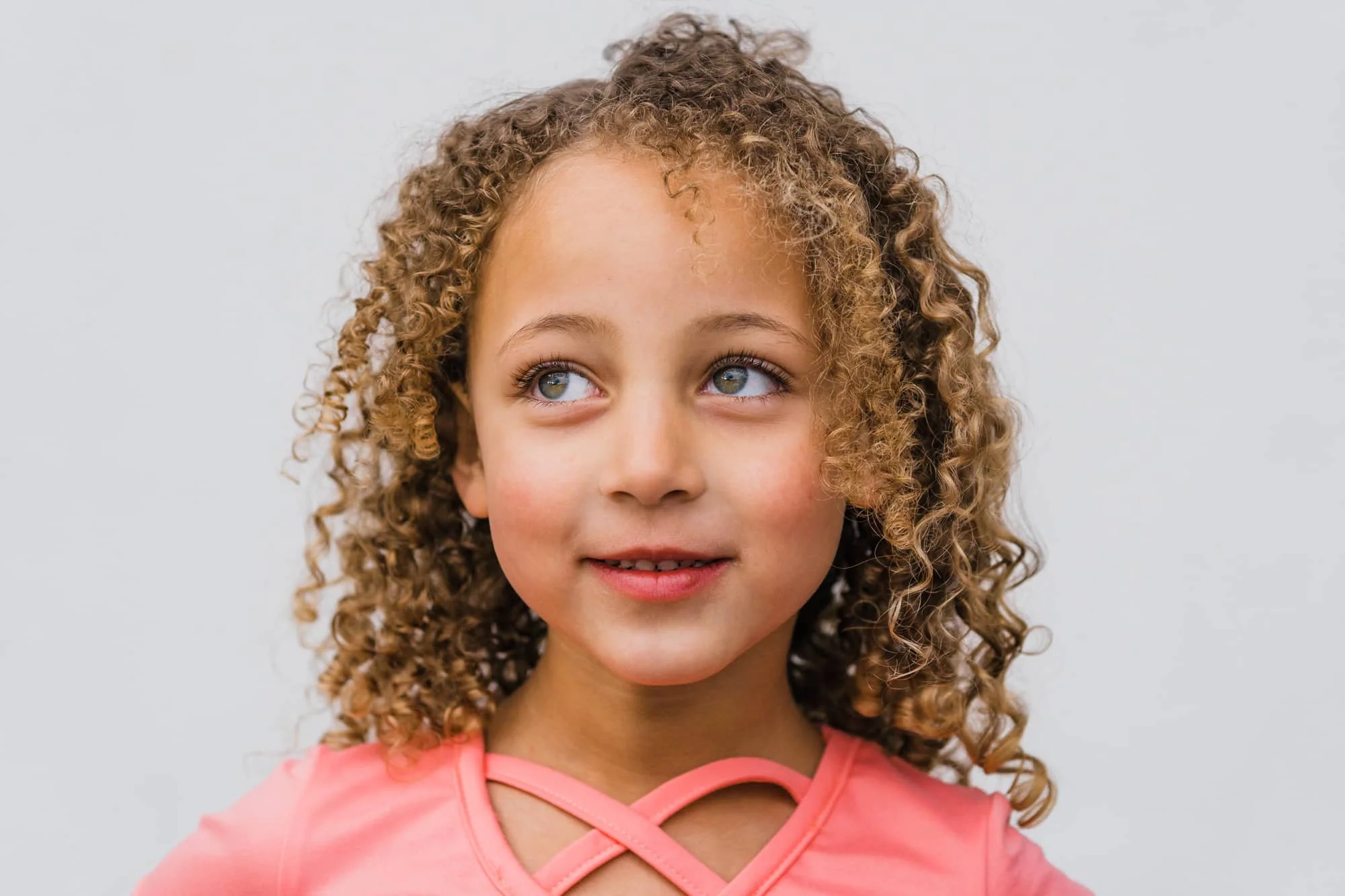 Close up headshot of girl smiling.