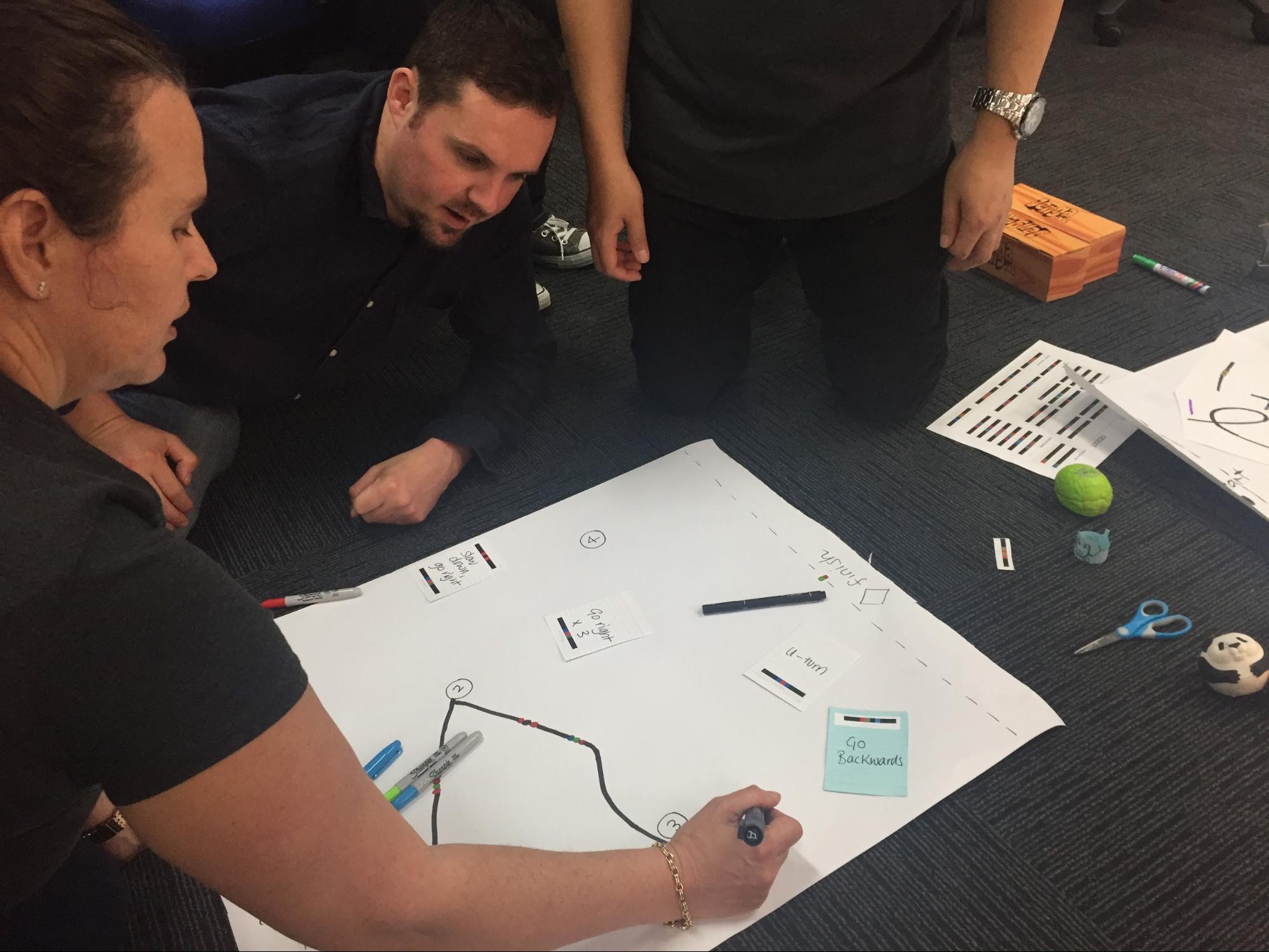 The team working on the second iteration of the obstacle course