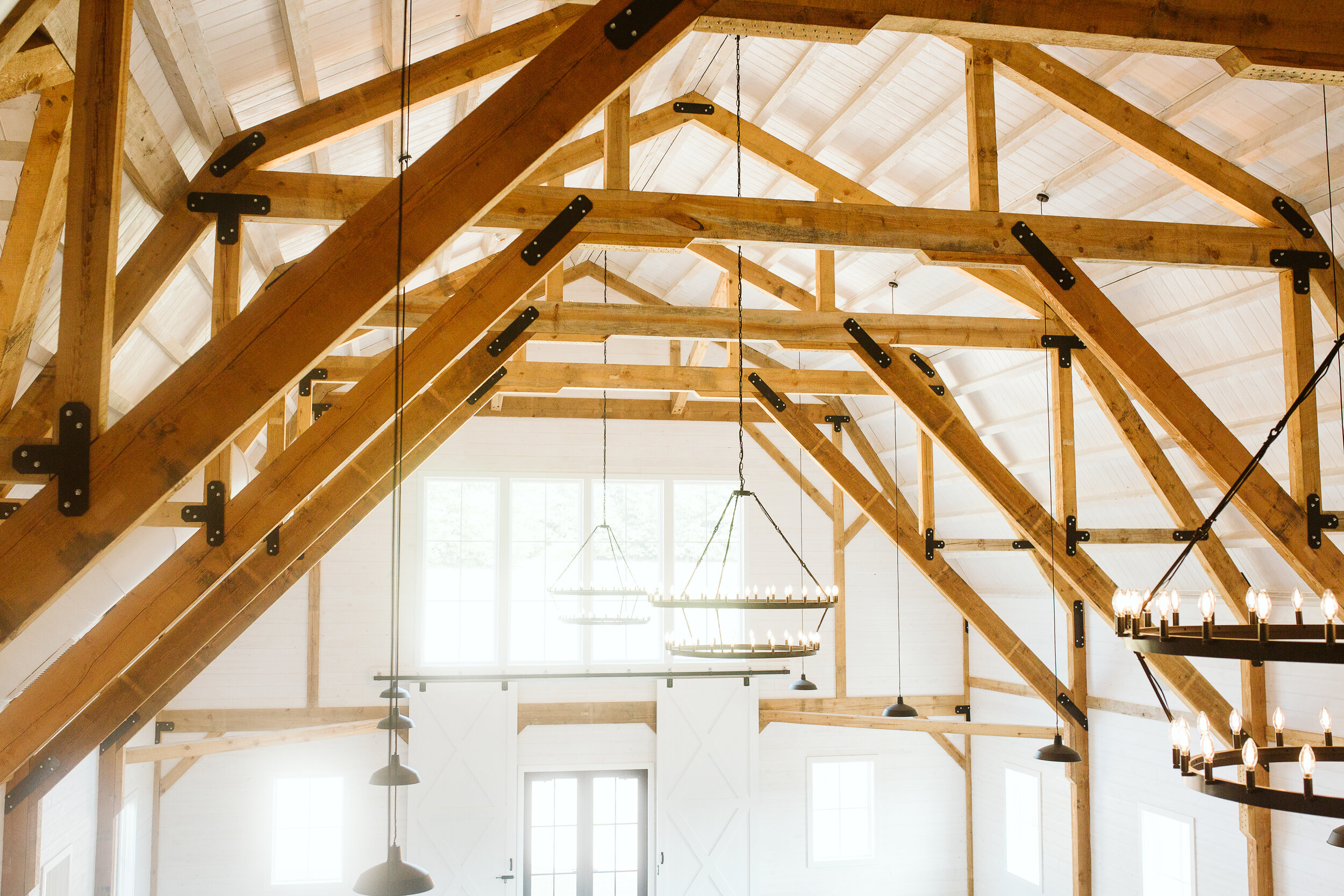  [PHOTO] A sunny Gambrel Room, featuring exposed wooden beams 