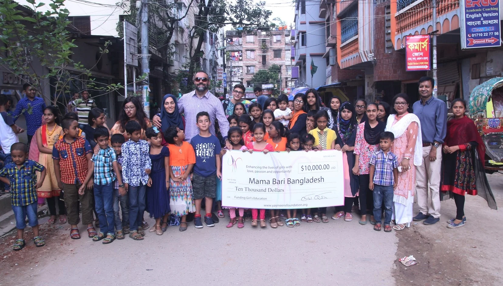 larger group with check outside.jpg