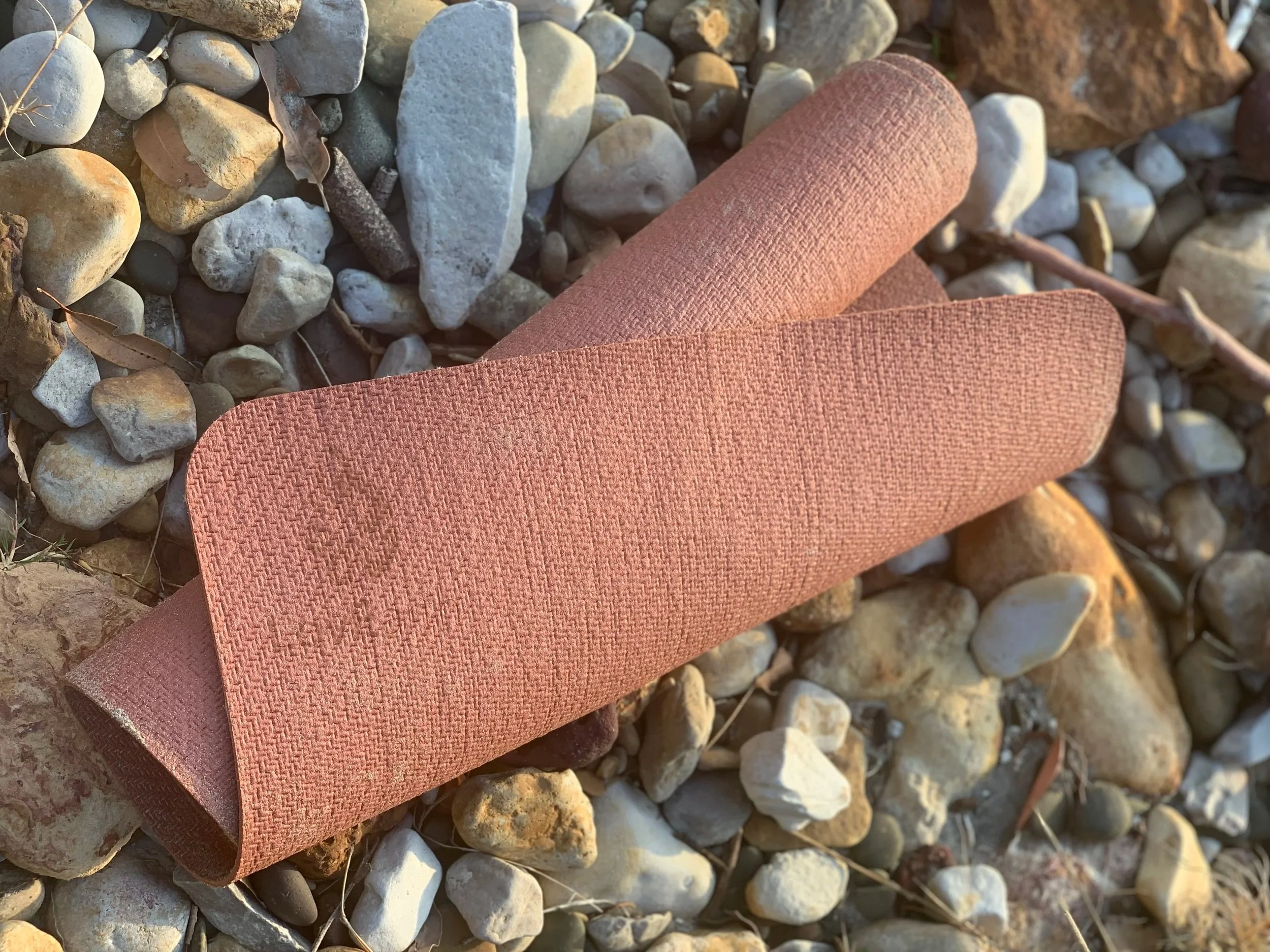 LovEarth 2mm natural rubber travel yoga mat in ochre, a lightweight plastic-free yoga mat for travel and everyday practice.