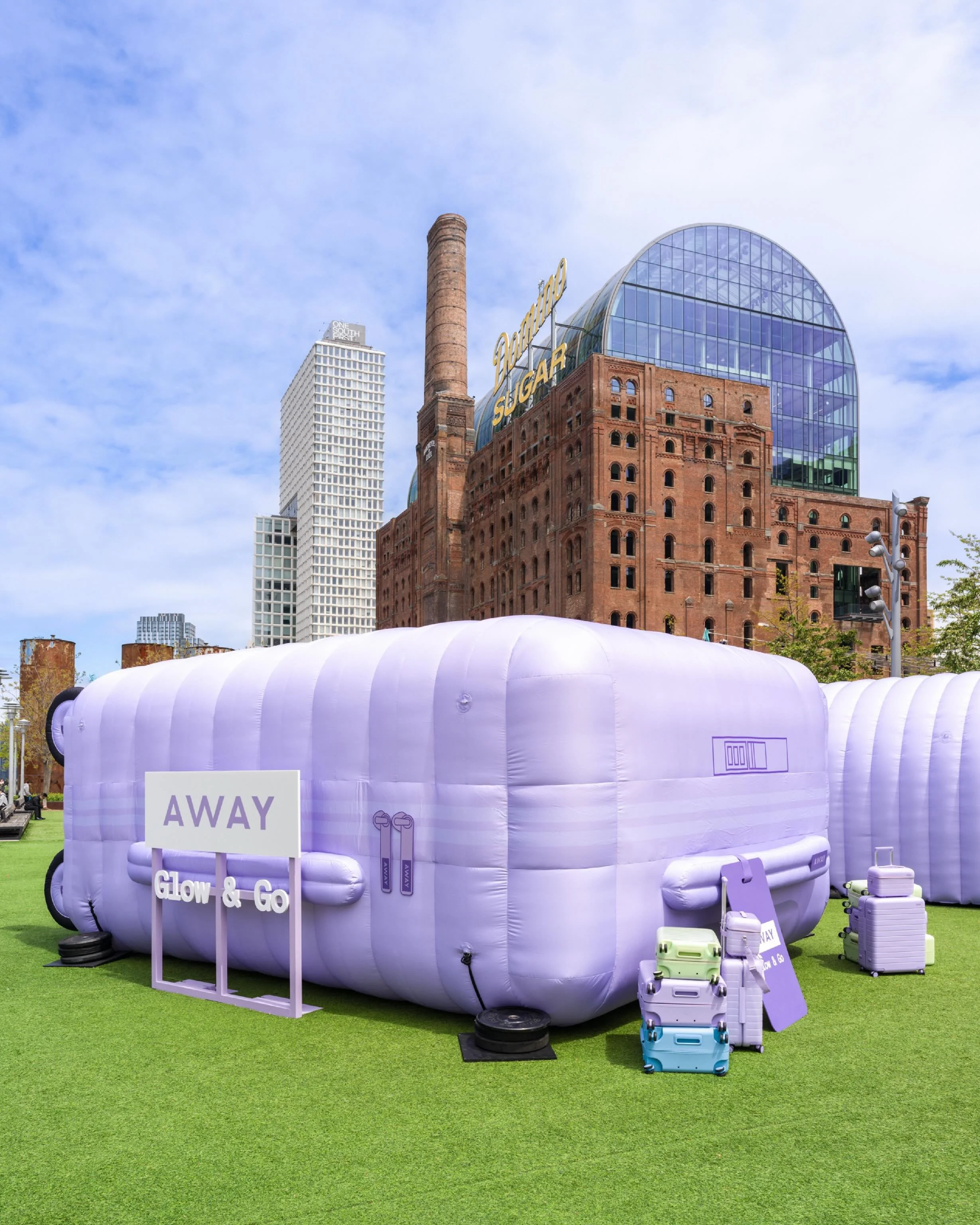 Definitely not fitting in the overhead bin.

For Away x Fenty Glow &amp; Go, we took over Domino Park with a 22&rsquo; lavender haze inflatable suitcase (yes, really), two 30&rsquo; immersive tunnels, and moving walkways designed to carry you through