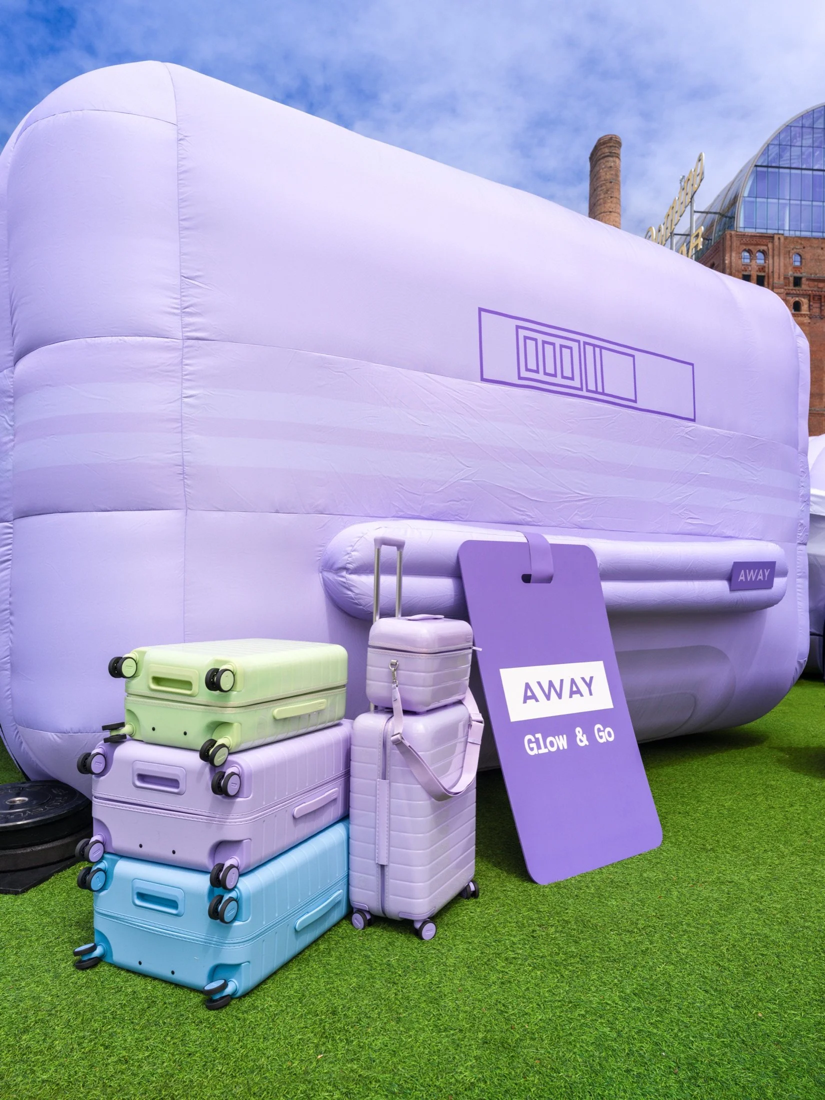 Lavender Away luggage beside the oversized Glow & Go suitcase