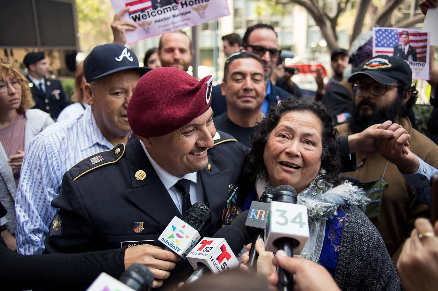 Spc. Hector Barajas, flanked by his parents, shakes hands with a supporter.