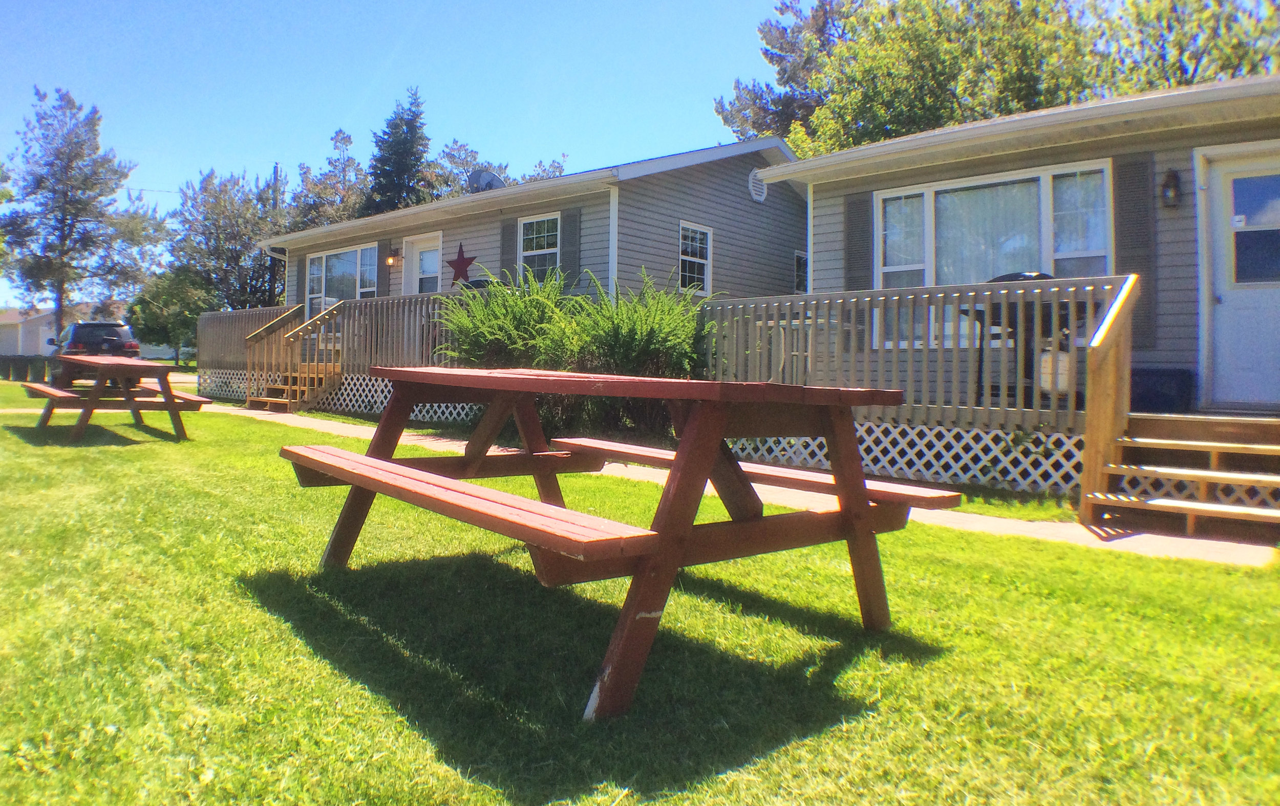Picnic tables in front of cottages
