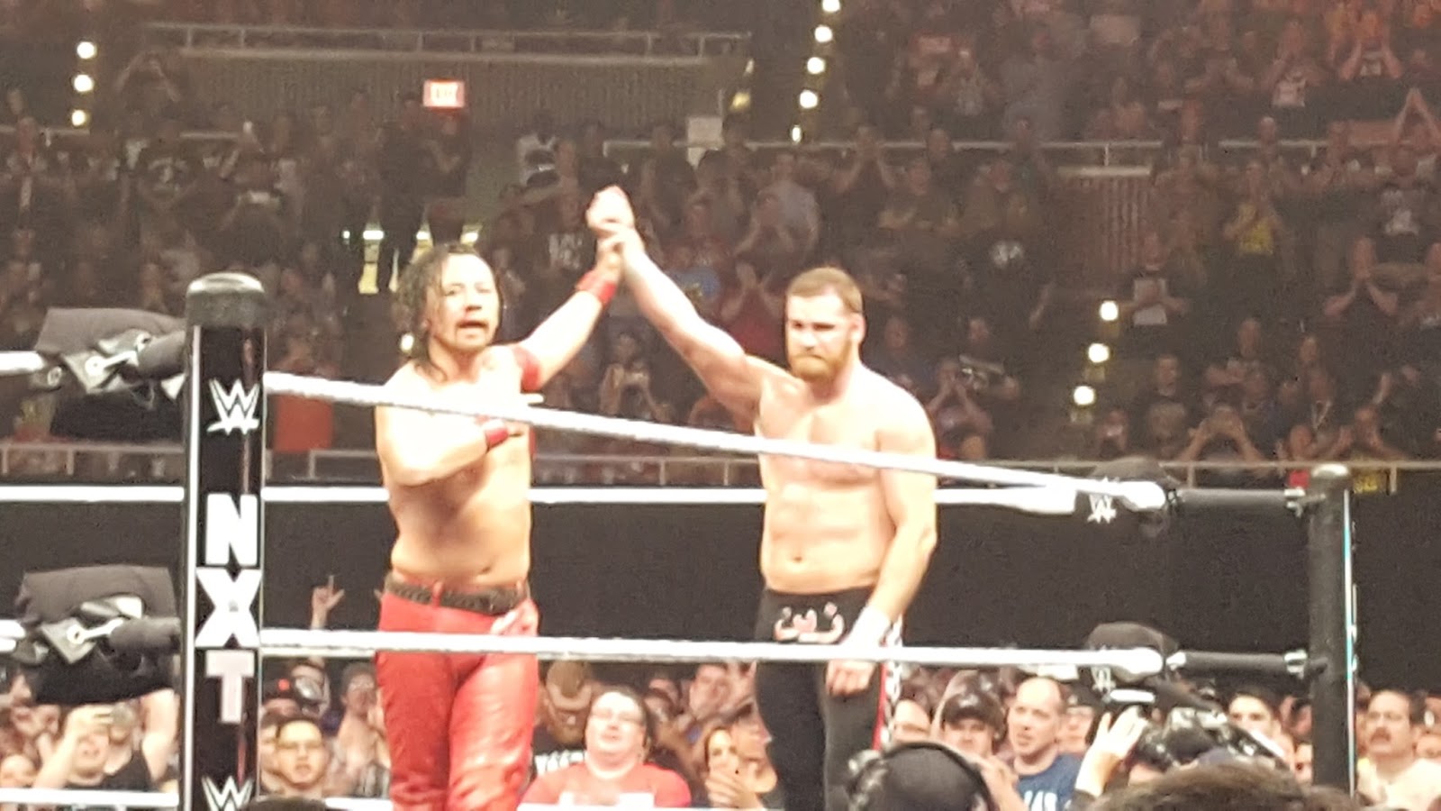 Nakamura and Zayn embrace following their match