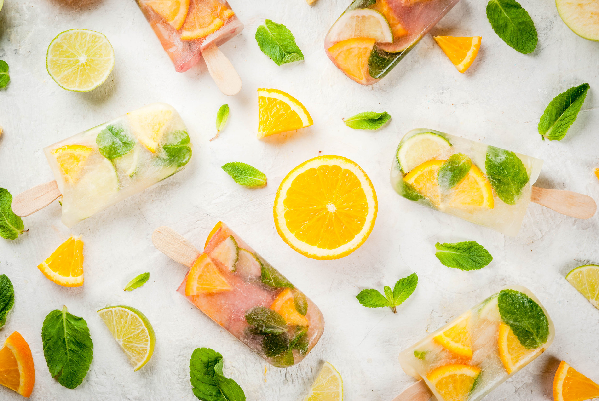 Popsicles of red, white sangria, lemonade or mojito. With oranges, lime, mint, apples..jpeg
