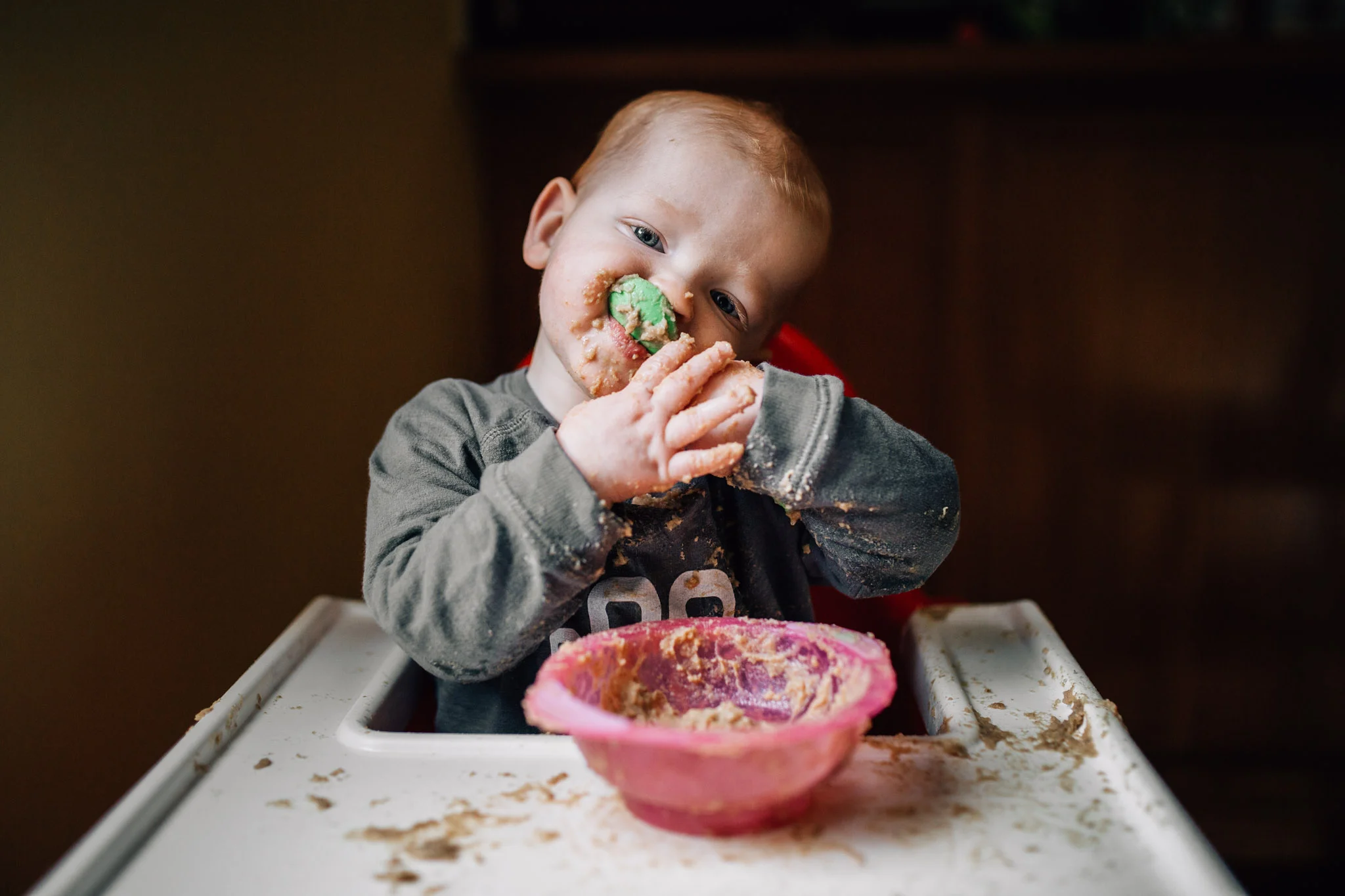 My son, feeding himself his breakfast like a boss in our Geelong dining room.