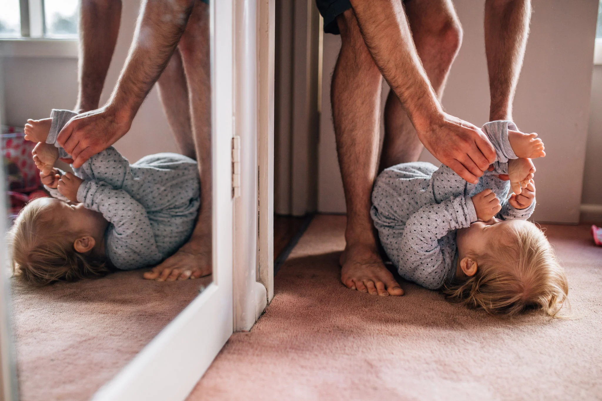 dad plays tickle game with toddler daughter.jpg
