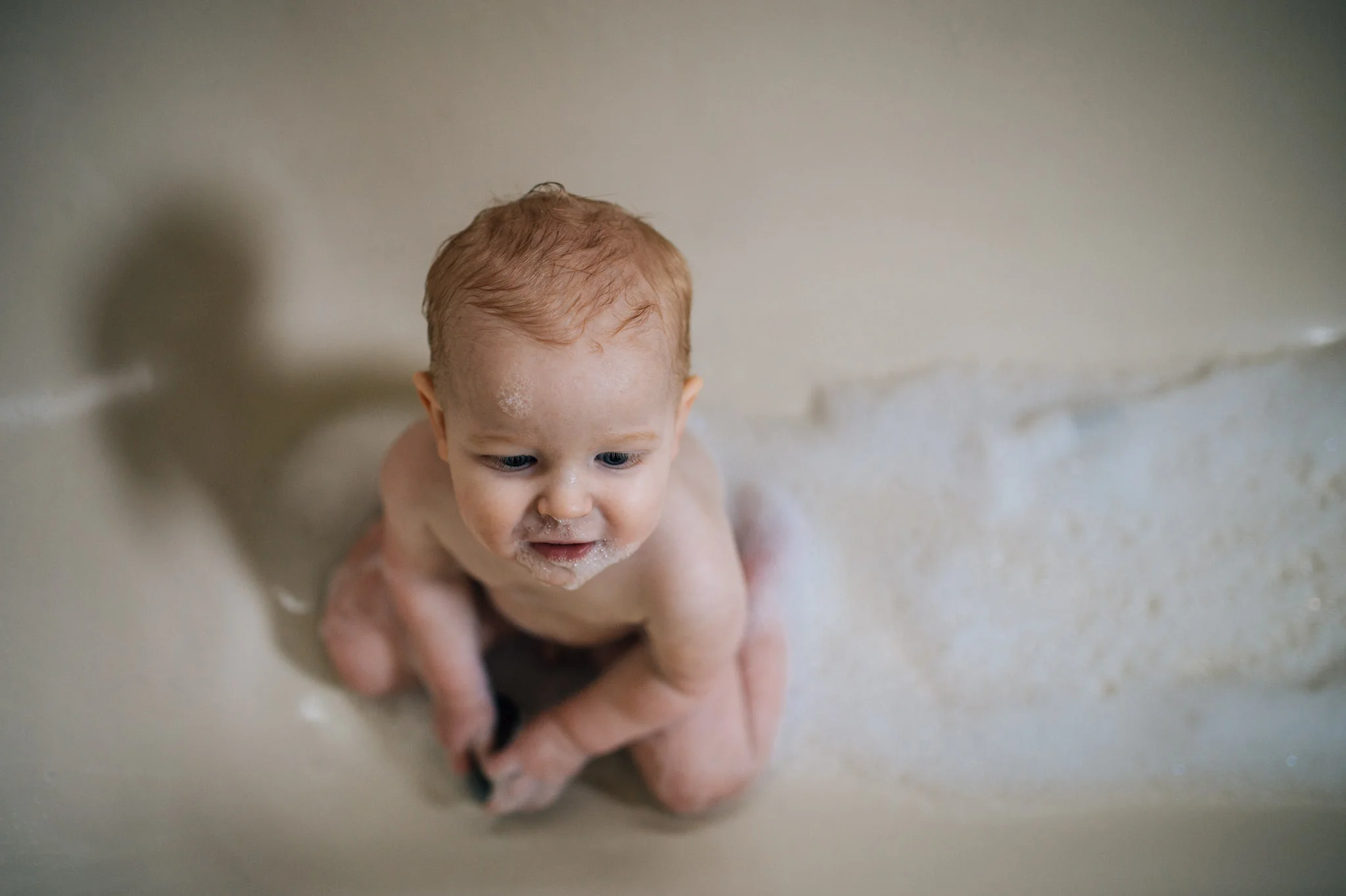 My son, after realising when you pull the plug the water drains out.