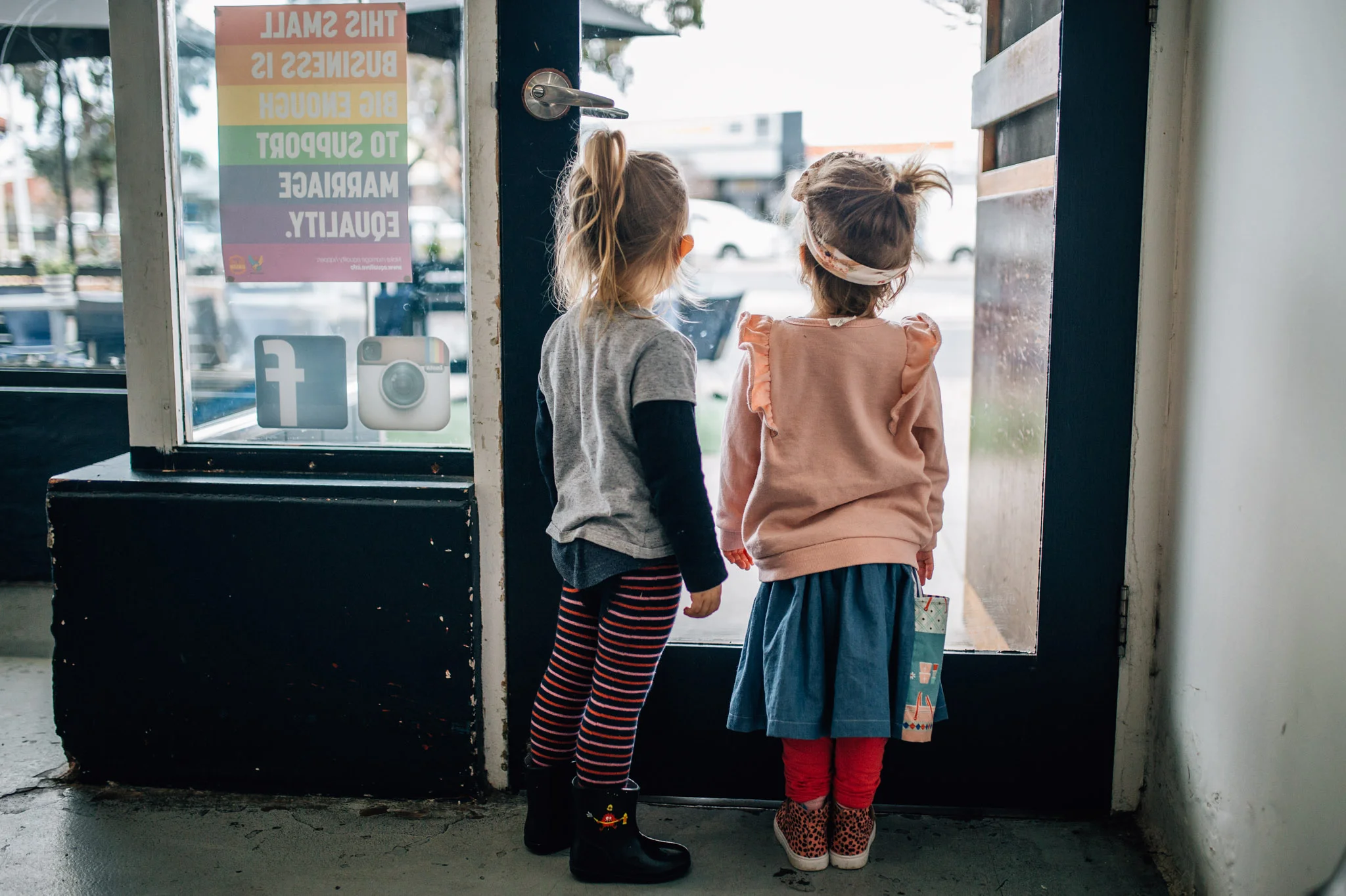 little girls looking out cafe window colour (1 of 1).jpg