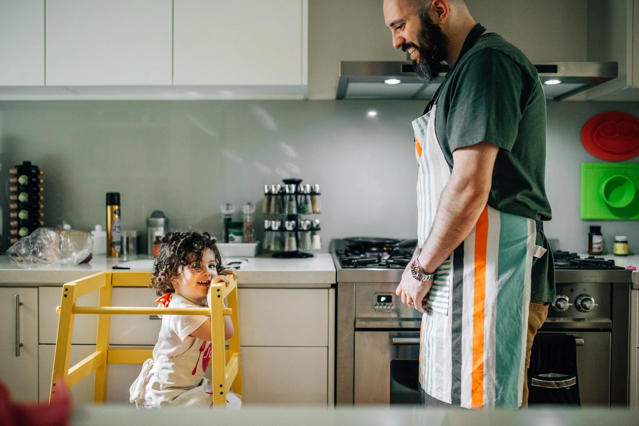 toddler-girl-squatting-on-learning-tower-in-kitchen-with-father (1 of 1).jpg