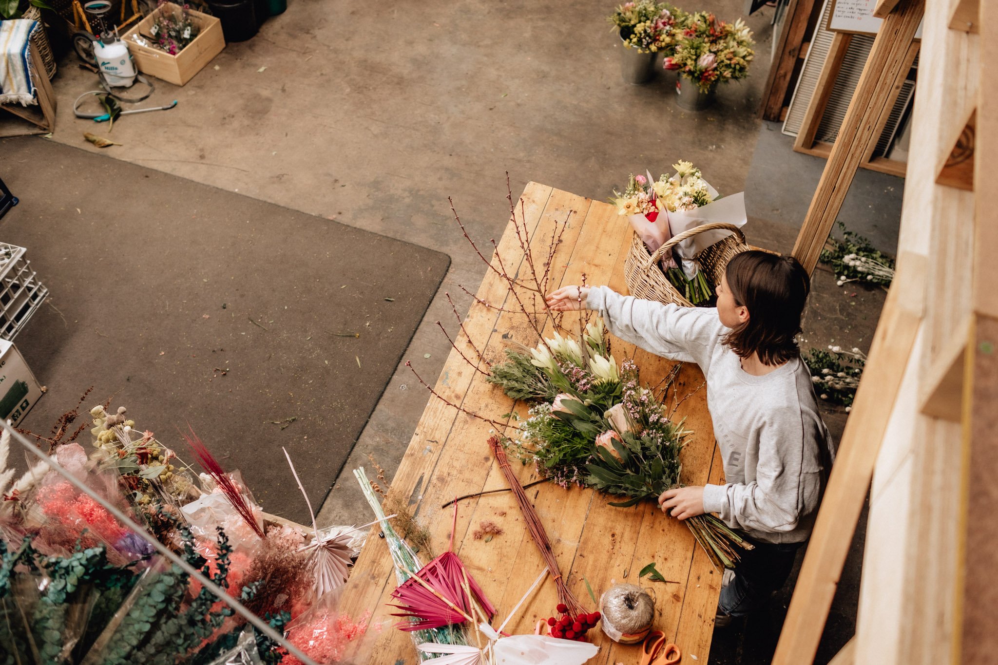 geelong artist arranging flowers at bench.jpg