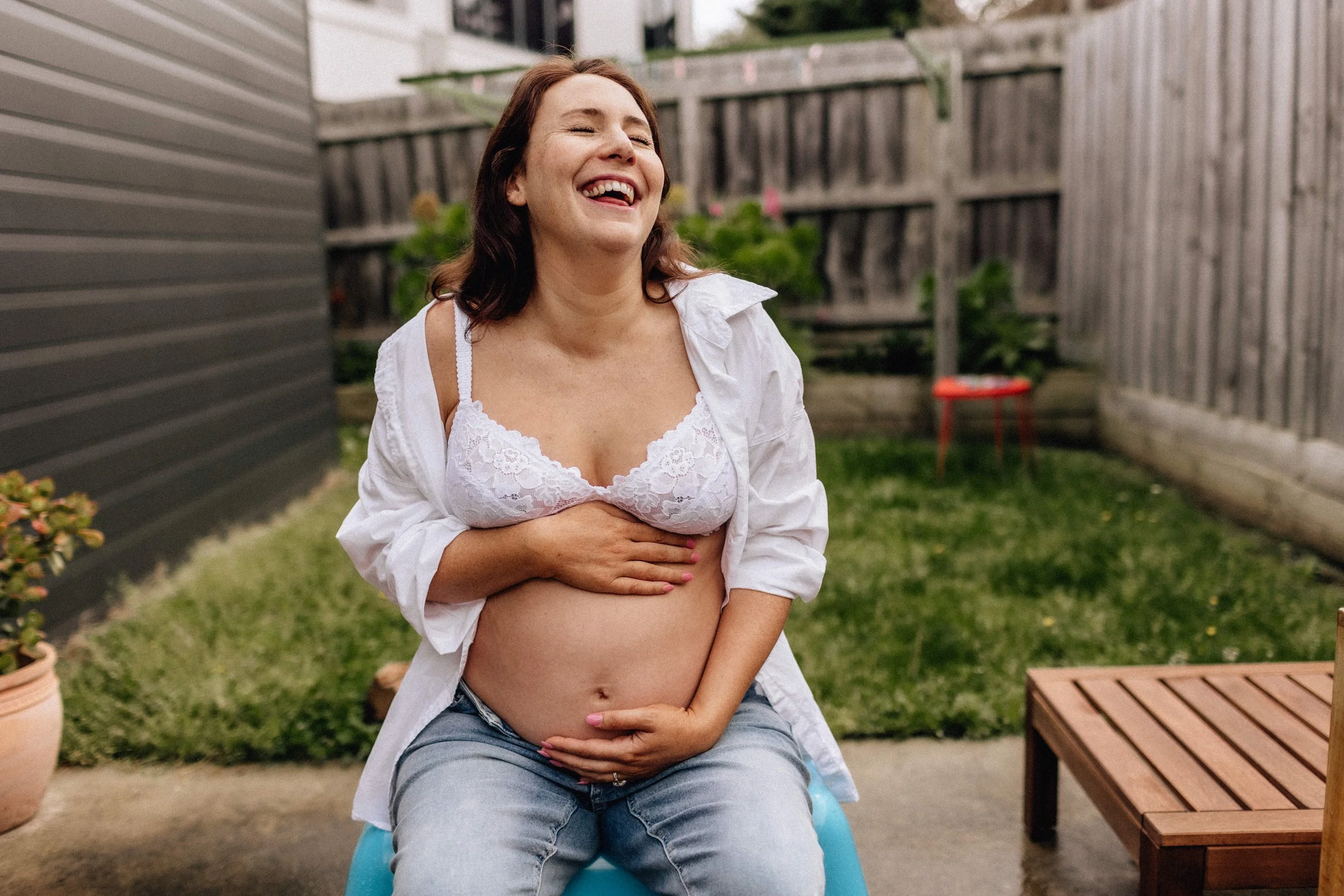 laughing pregant mother in geelong backyard.jpg