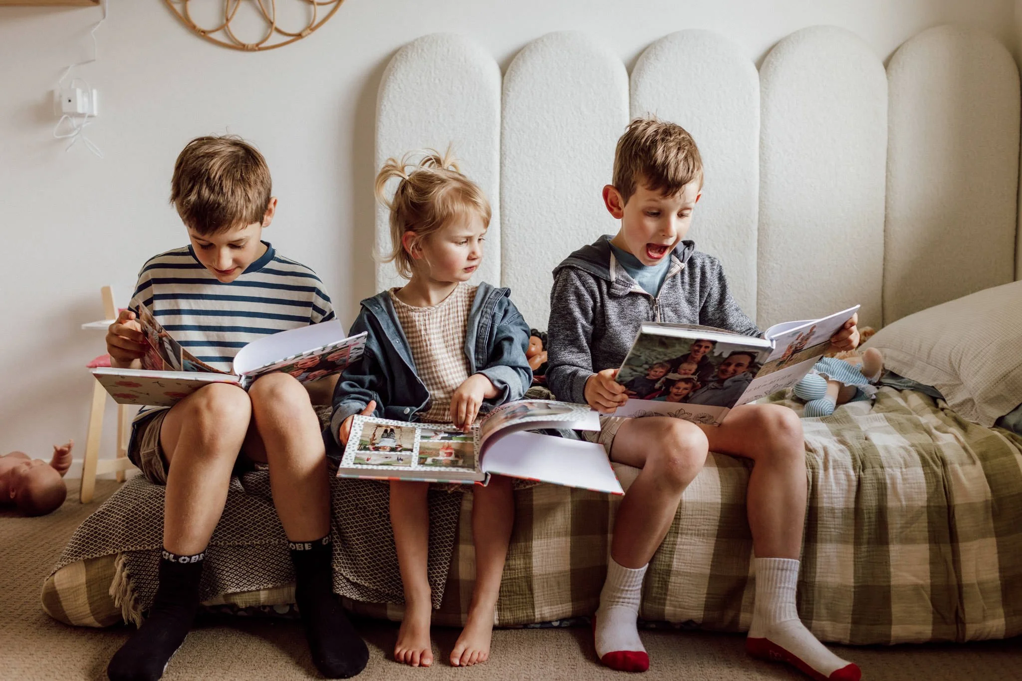 ballarat children looking at photo albums in bedroom.jpg