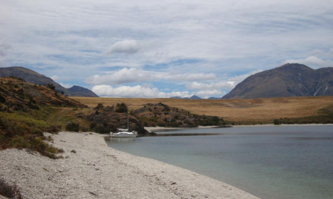 Outer Minaret Bay. It looks benign, but wind gusts continually were sweeping over the low ground to the north (left), and coming into shore under sail was quite tricky.