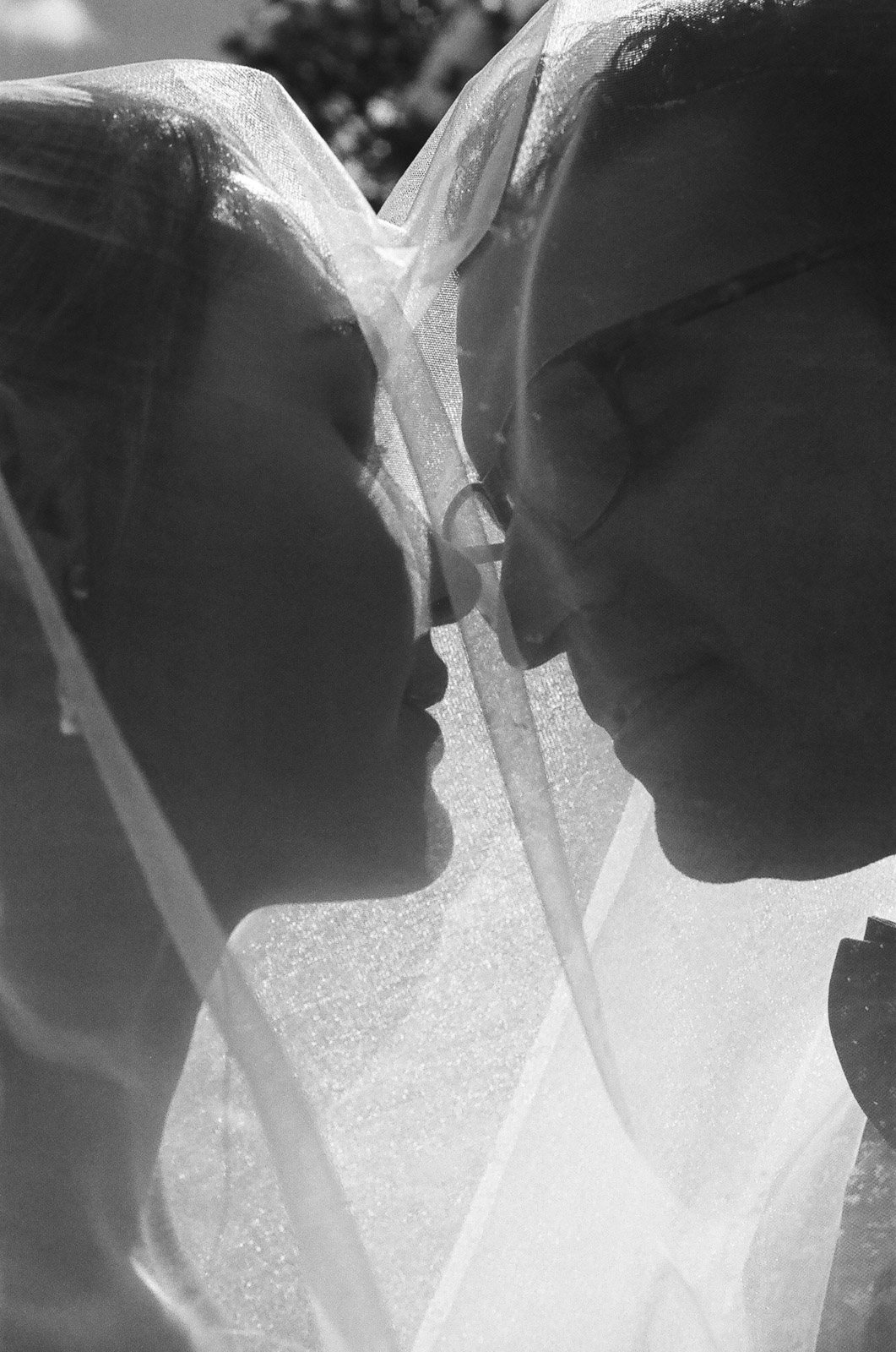  black and white 35mm film photograph of bride and groom Kissing under the veil taken by Joseph Barber wedding photography newport beach