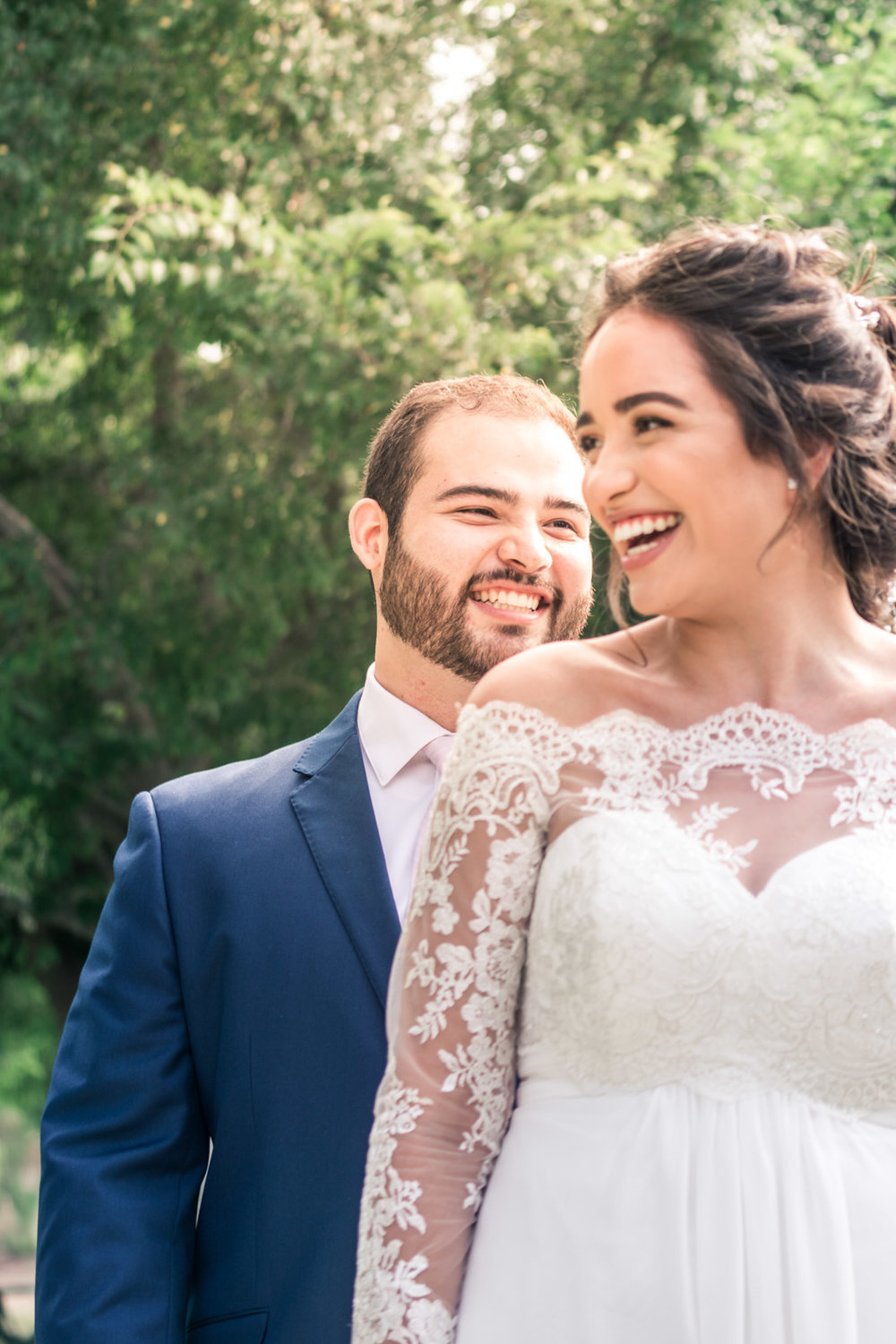 Portrait of the Bride and groom laughing and smiling   during the first book on their wedding day in Brea California