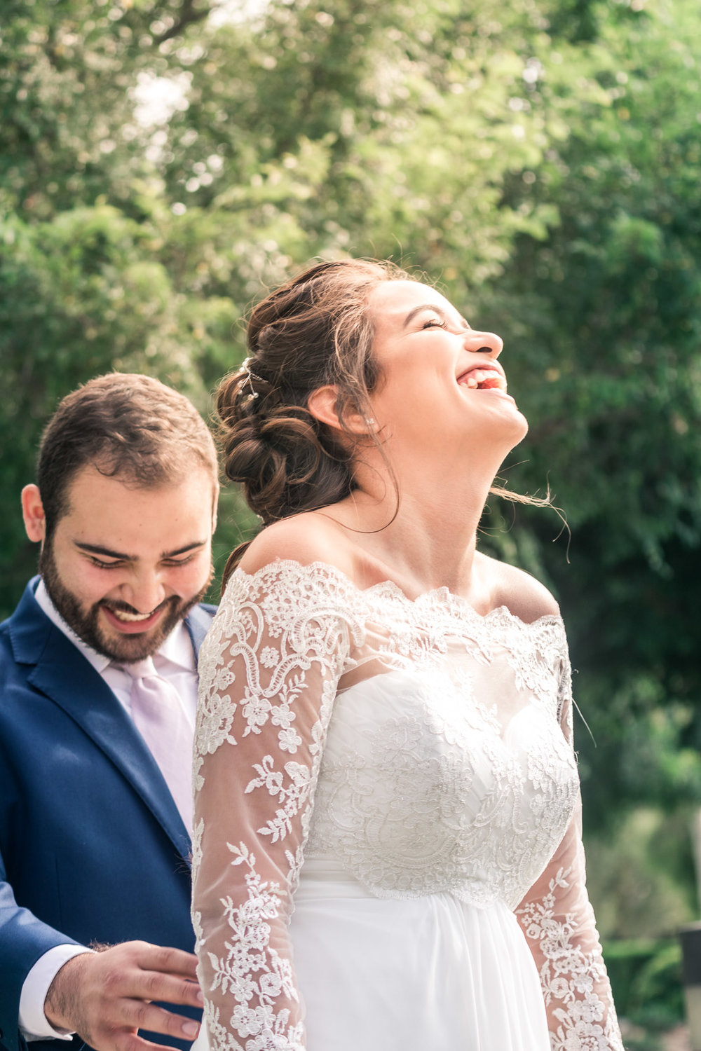 Portrait of the Bride and groom laughing and smiling   during the first book on their wedding day in Brea California