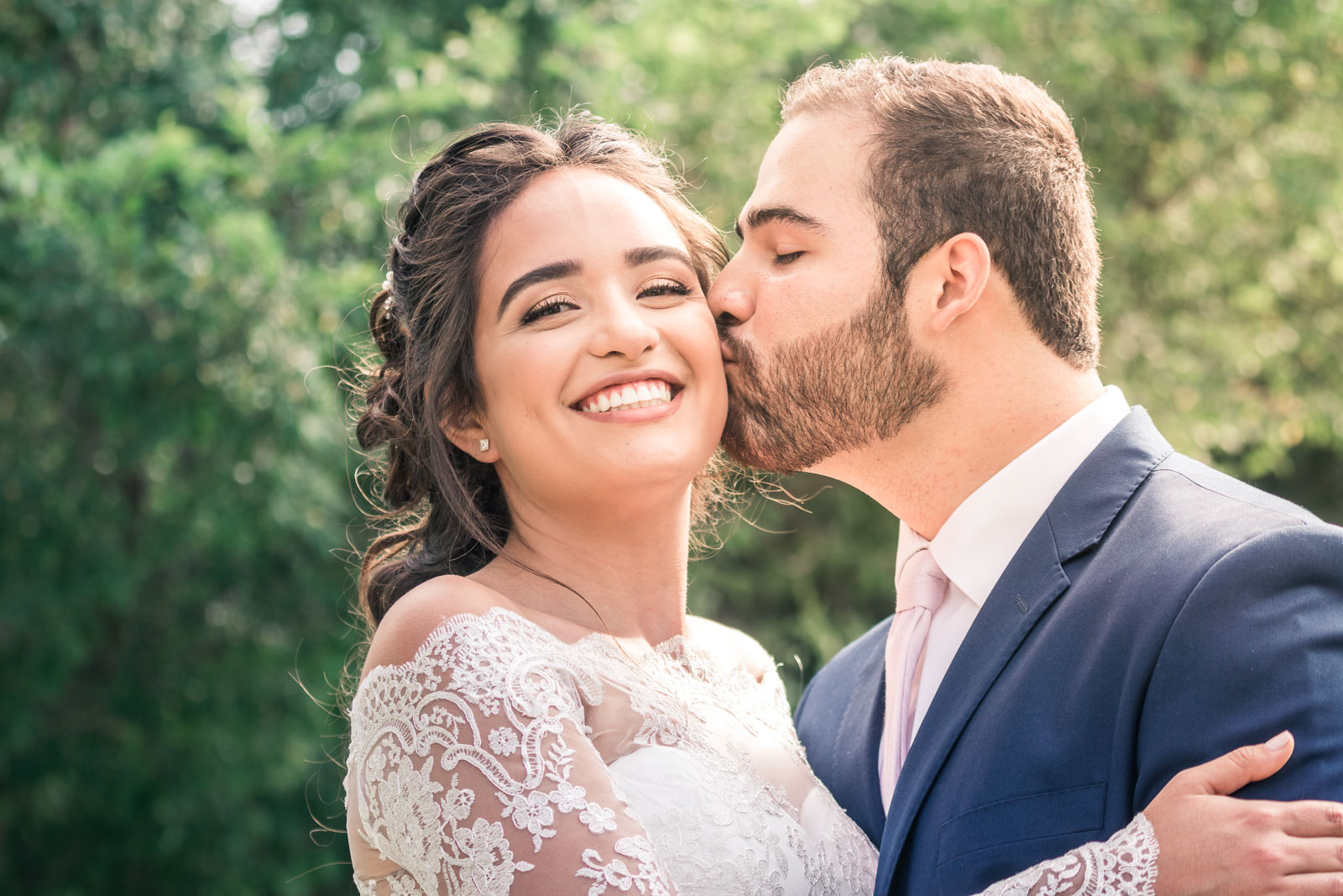Portrait of the Bride and Kissing and smiling   during the first book on their wedding day in Brea California