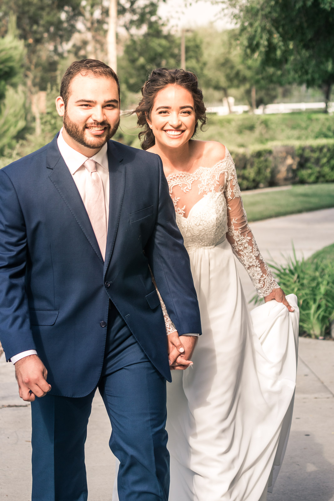 Portrait of the Bride and Holding hands and smiling   during the first book on their wedding day in Brea California