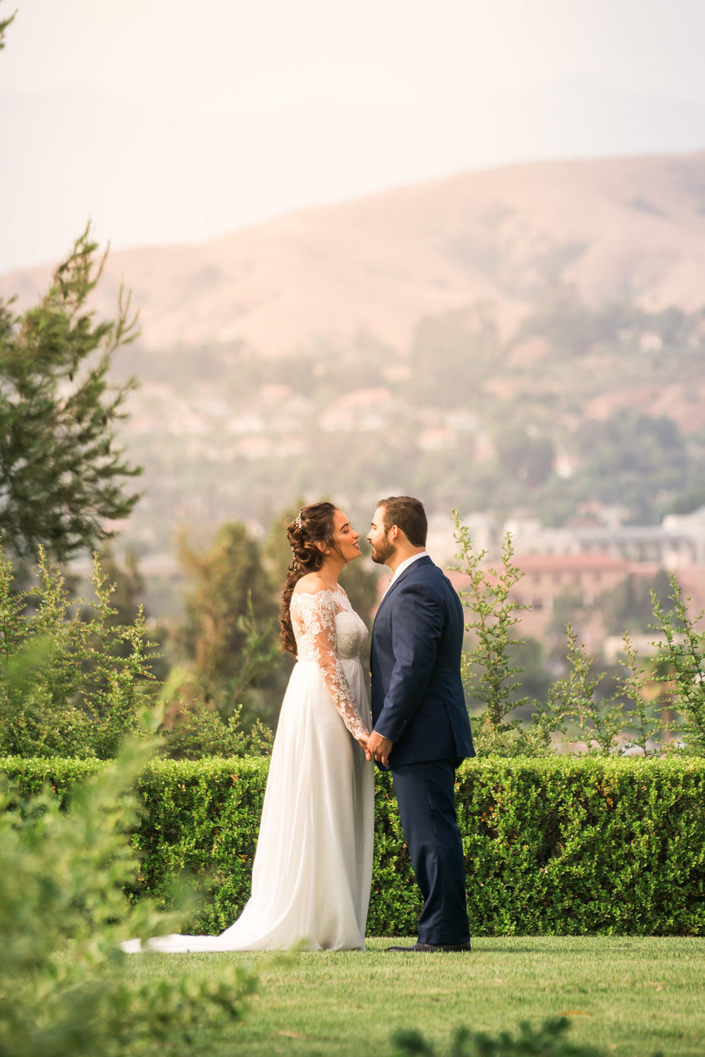 Portrait of the Bride and Holding hands and smiling   during the first book on their wedding day in Brea California