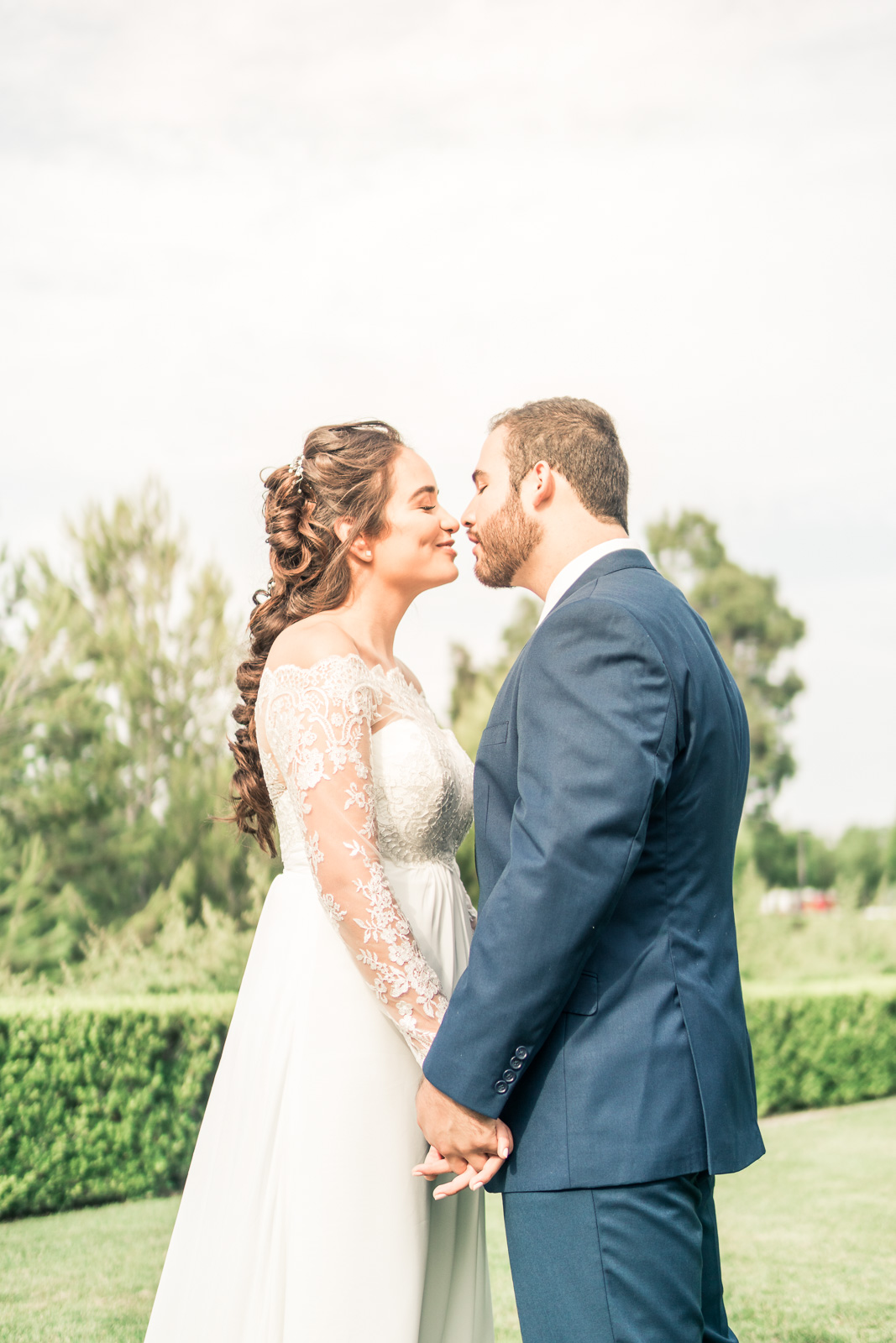 Portrait of the Bride and Holding hands and smiling   during the first book on their wedding day in Brea California