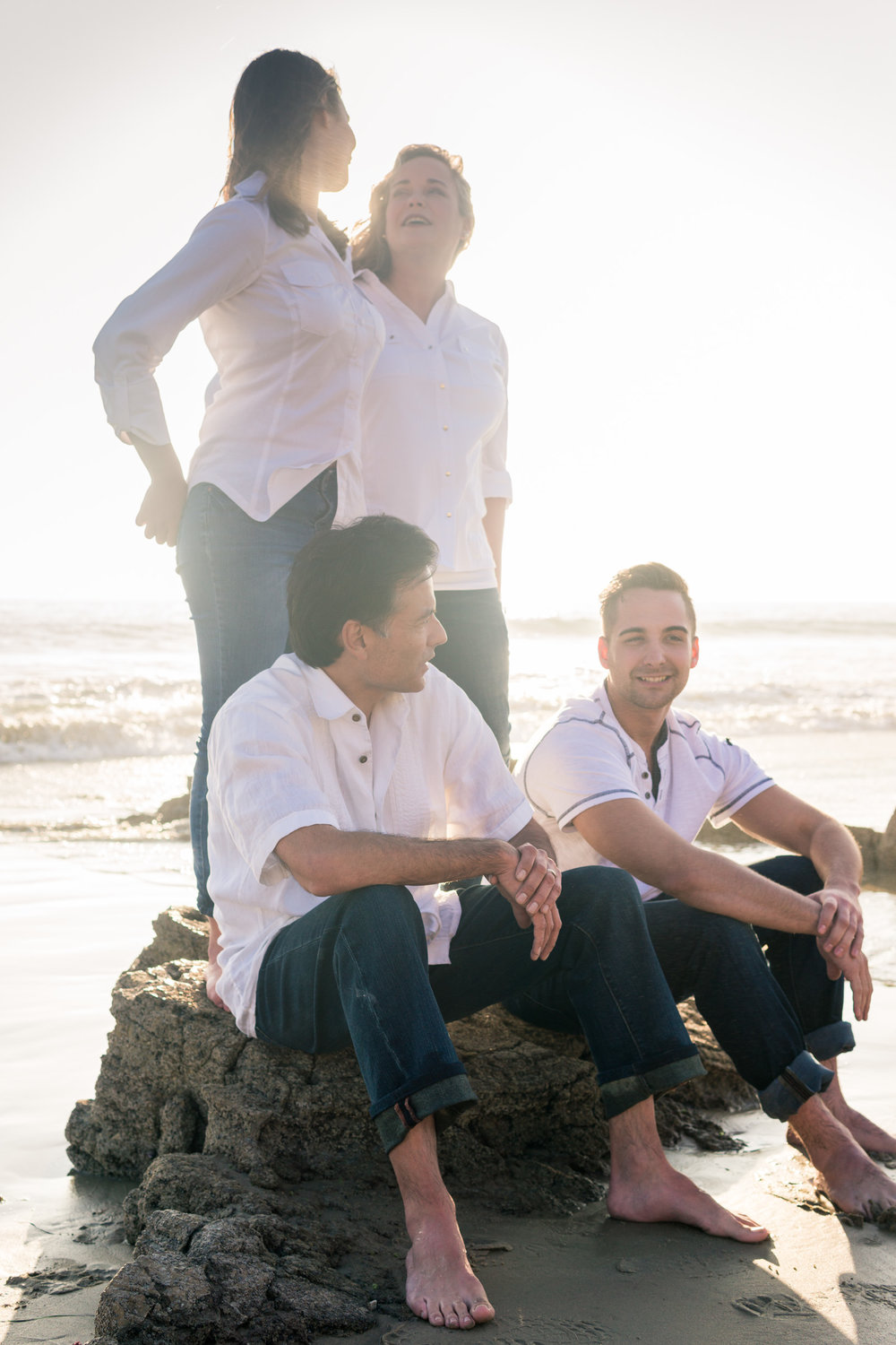 Family portraits being backlit during Golden hour at Crystal Cove State Beach in Newport