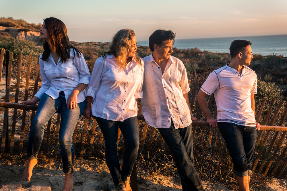 Family portraits of family posing on stairs during Golden hour at Crystal Cove State Beach in Newport