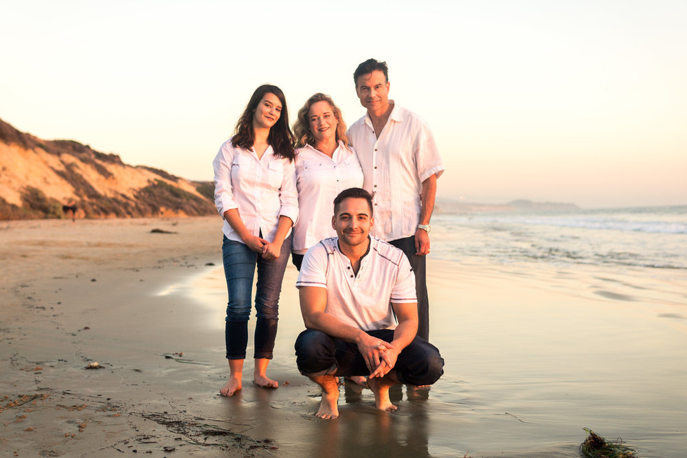 Family portraits of family enjoying the sunset together during Golden hour at Crystal Cove State Beach in Newport