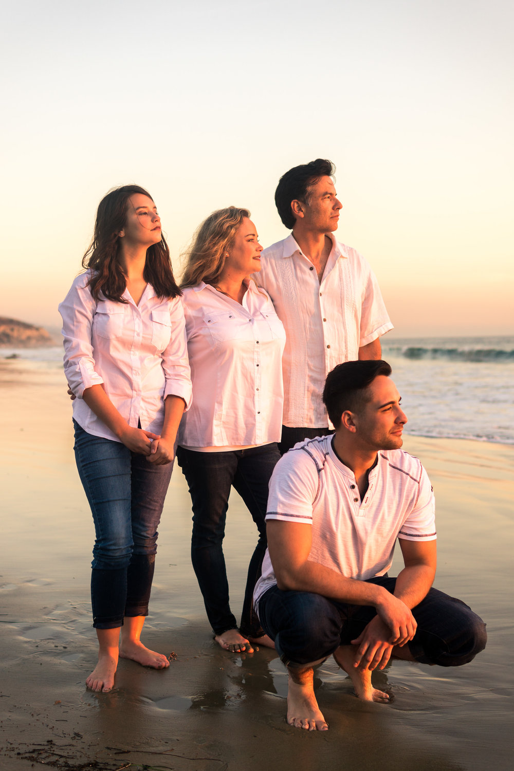 Family portraits of family enjoying the sunset together during Golden hour at Crystal Cove State Beach in Newport