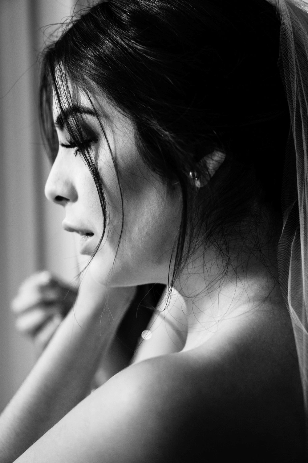 Black-and-white candid portrait of bride getting ready On Balboa Island before the ceremony
