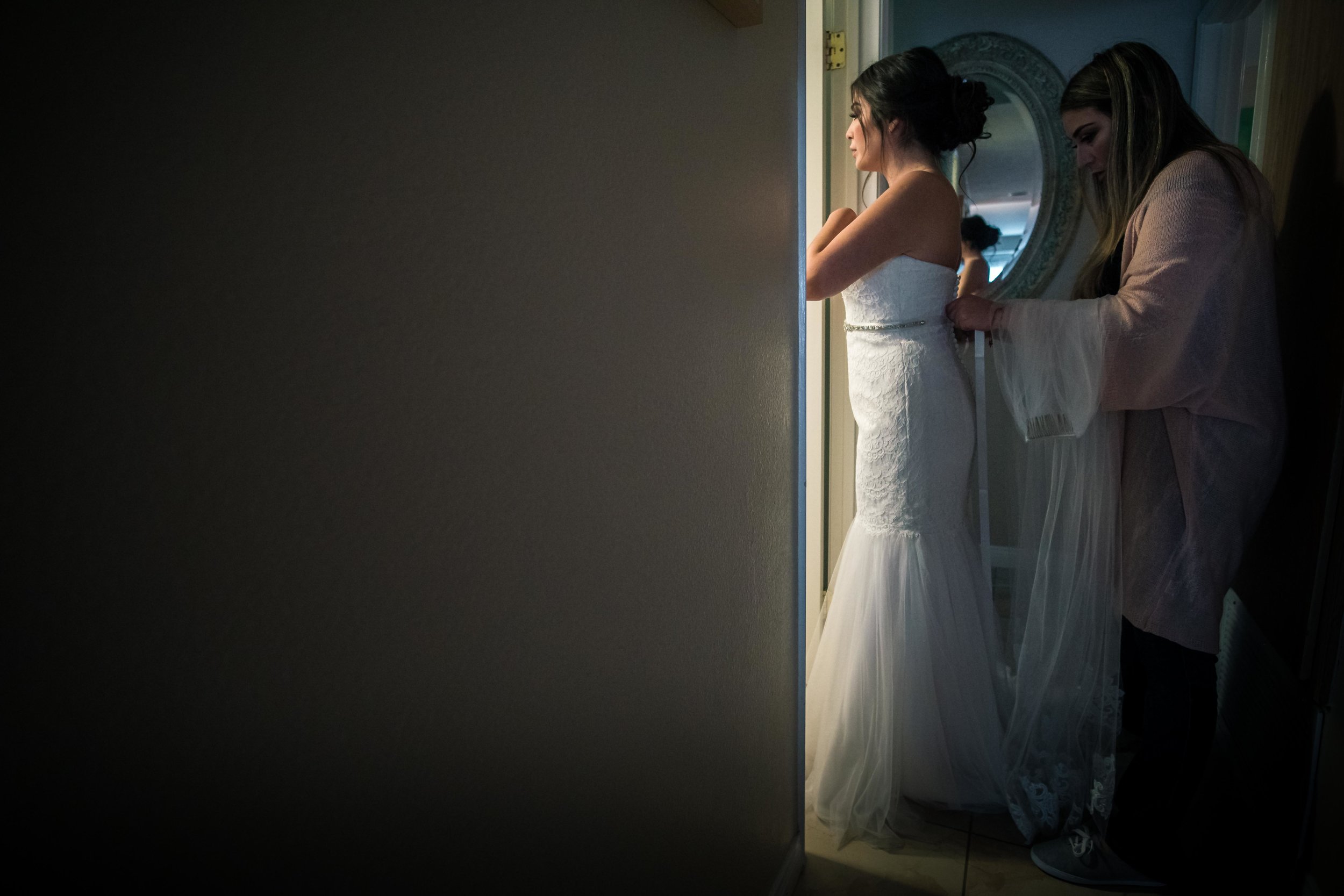A minimal composition of the bride getting ready with your mother During her wedding preparation