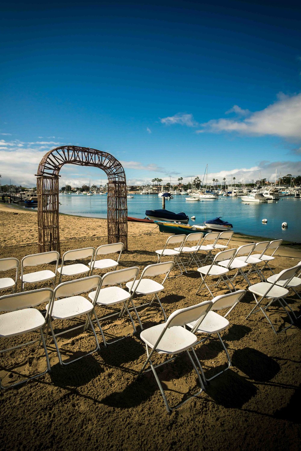 The wedding ceremony before the guests arrive on the beach on diamond street on Balboa Island Newport Beach