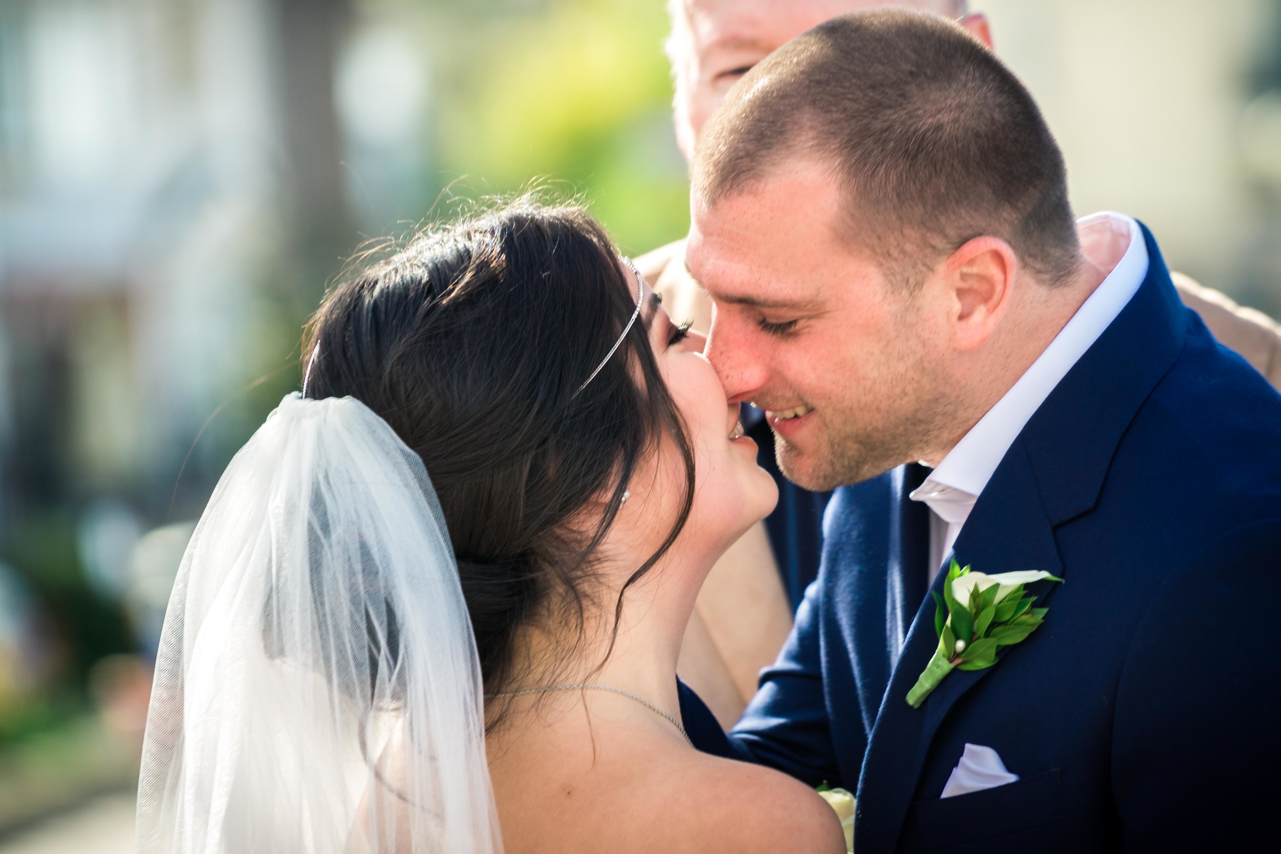 The bride and groom kissing at the altar