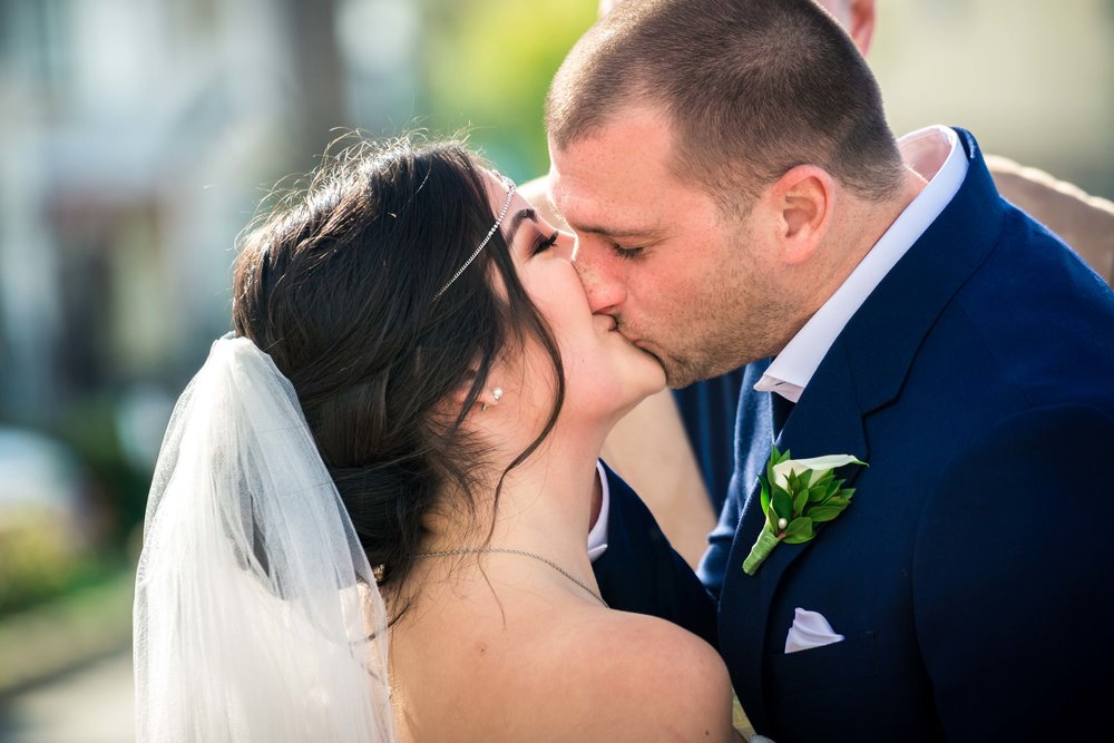 The bride and groom kissing at the altar During their ceremony