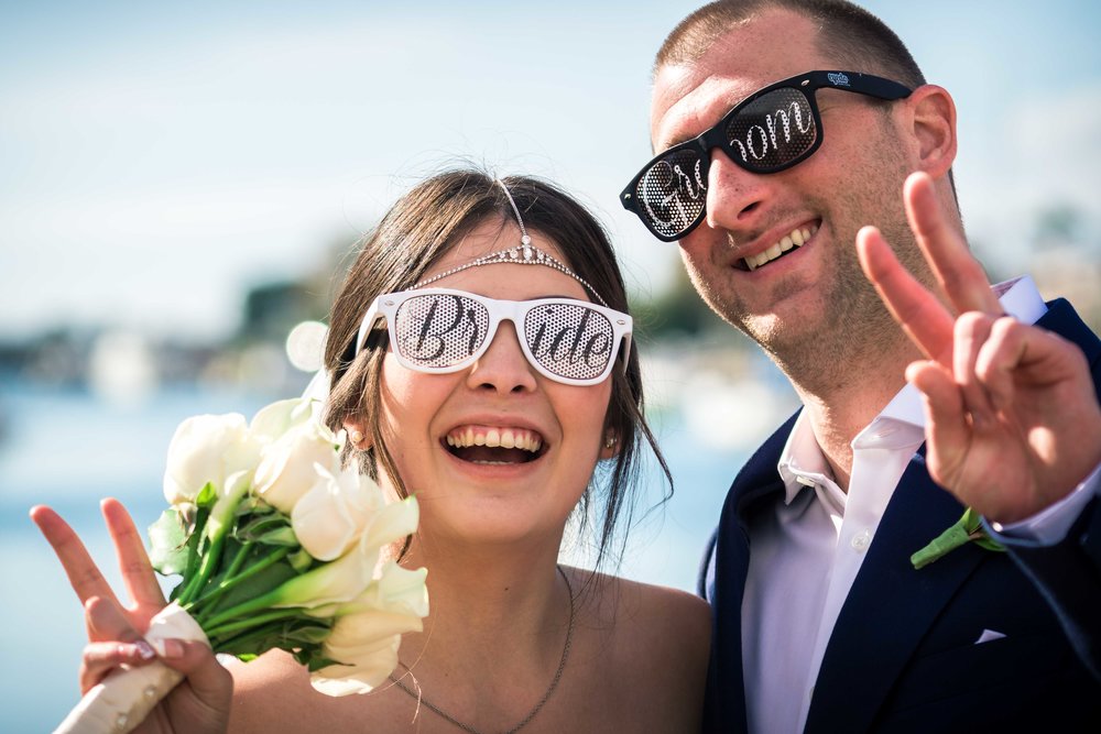 Bride and groom wearing sunglasses and being goofy